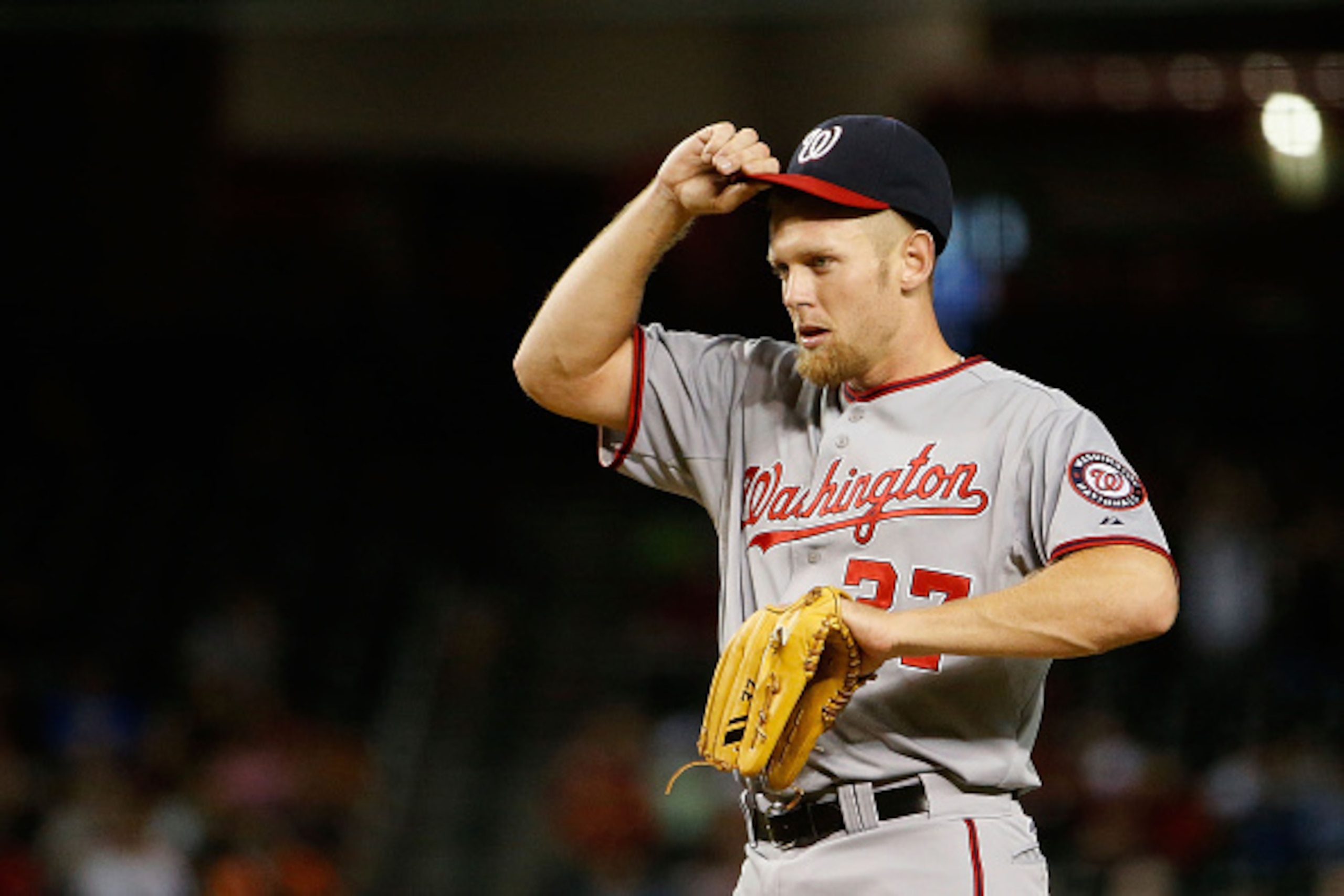 PHOENIX, AZ - MAY 12:  Starting pitcher Stephen Strasburg #37 of the Washington Nationals reacts after giving up a sacrifice fly to Ender Inciarte (not pictured) during the fourth inning of the MLB game at Chase Field on May 12, 2015 in Phoenix, Arizona. 