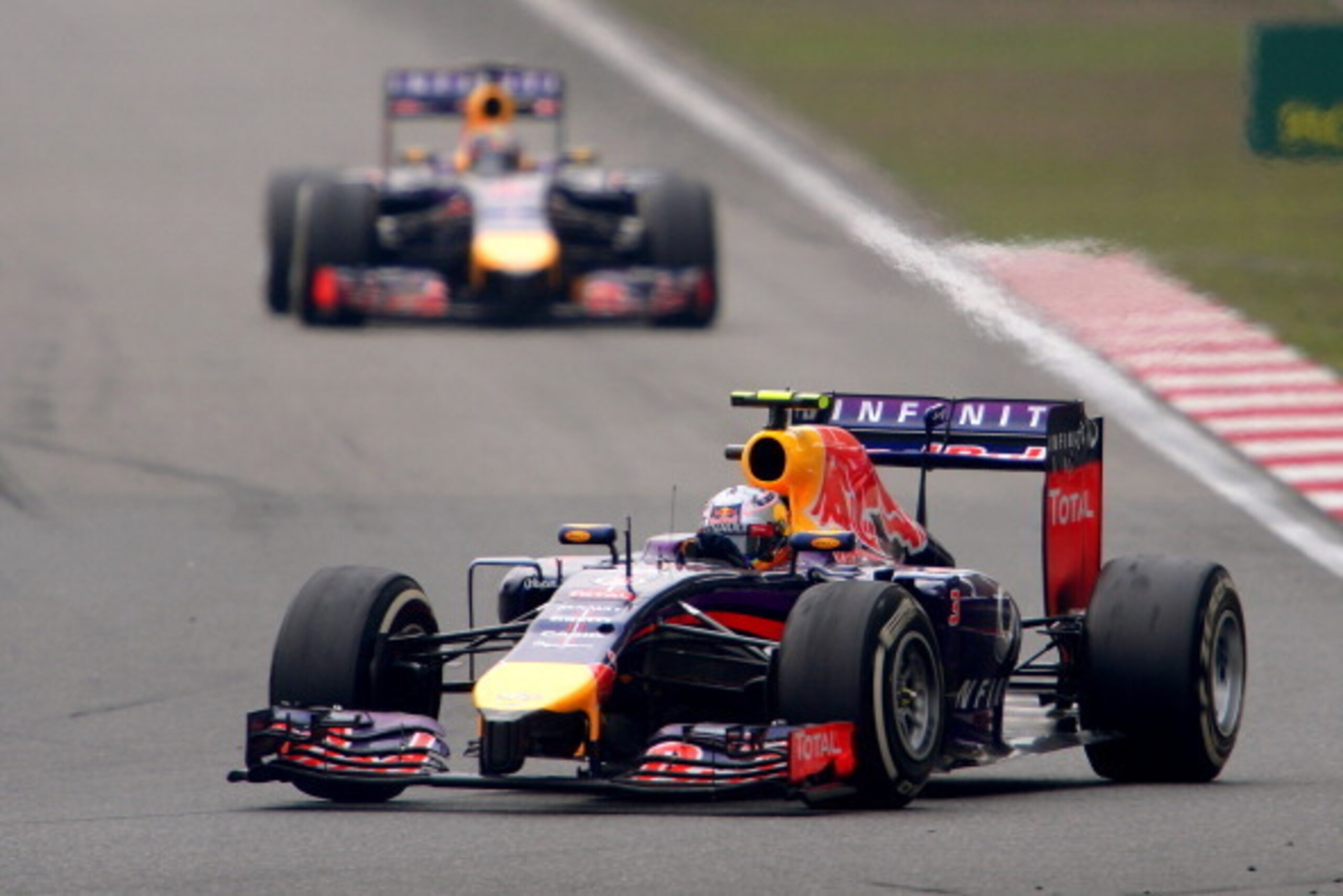 SHANGHAI, CHINA - APRIL 20:  Daniel Ricciardo of Australia and Infiniti Red Bull Racing  leads teammate Sebastian Vettel of Germany and Infiniti Red Bull Racing during the Chinese Formula One Grand Prix at the Shanghai International Circuit on April 20, 2