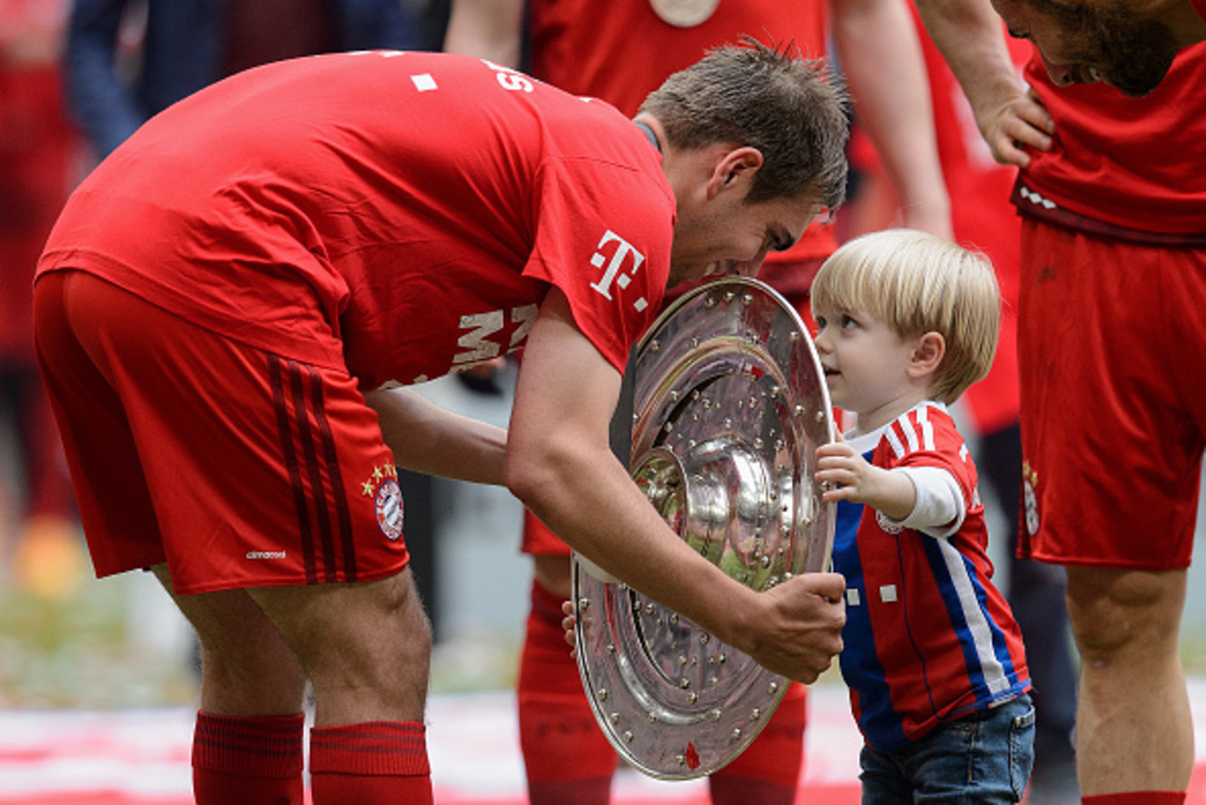MUNICH, GERMANY - MAY 23:  Philipp Lahm of Muenchen presents the Bundesliga trophy to his son Julian after winning the league during the Bundesliga match between FC Bayern Muenchen and 1. FSV Mainz 05 at Allianz Arena on May 23, 2015 in Munich, Germany.  