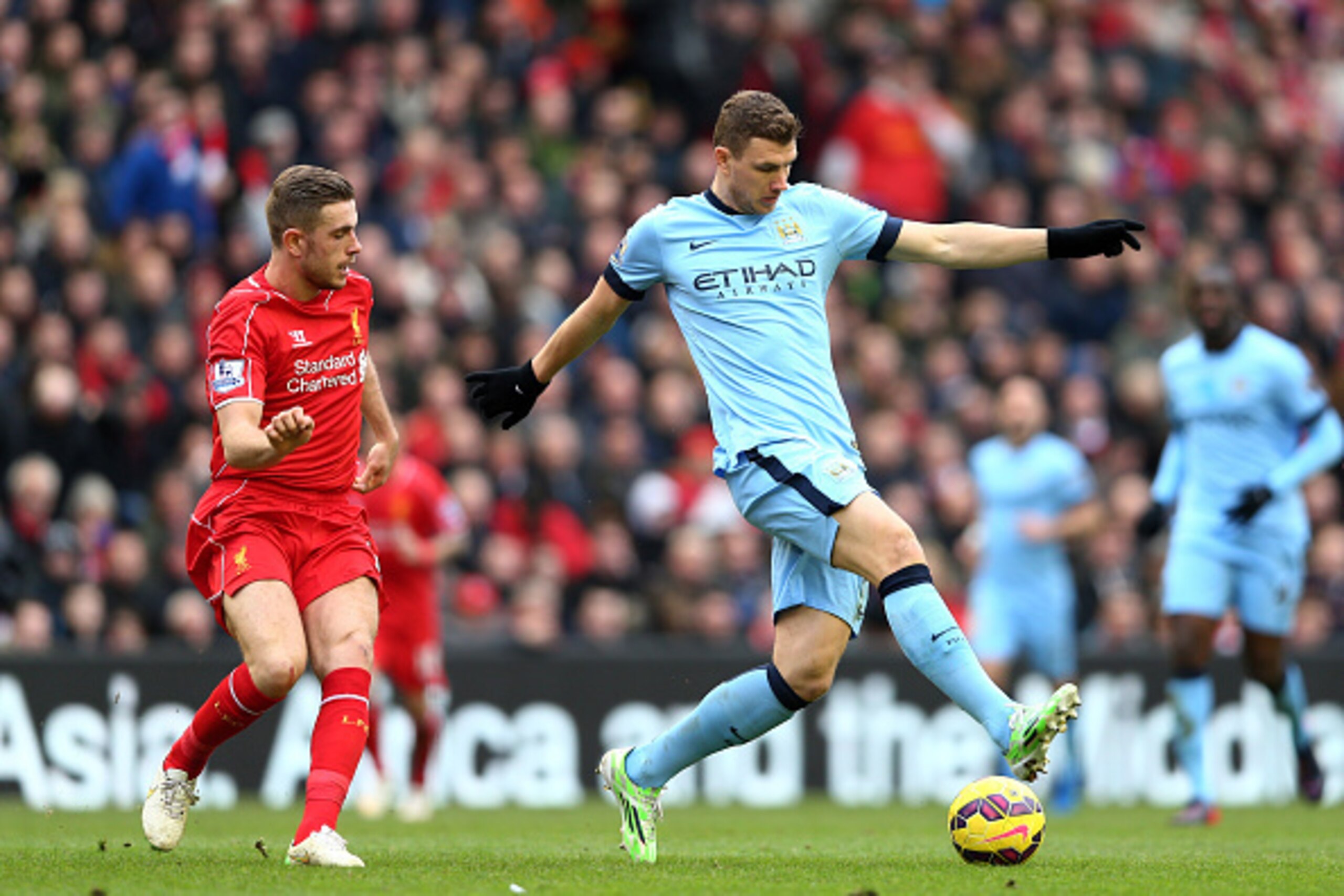LIVERPOOL, ENGLAND - MARCH 01:  Edin Dzeko of Manchester City is closed down by Jordan Henderson of Liverpool during the Barclays Premier League match between Liverpool and Manchester City at Anfield on March 1, 2015 in Liverpool, England.  (Photo by Cliv