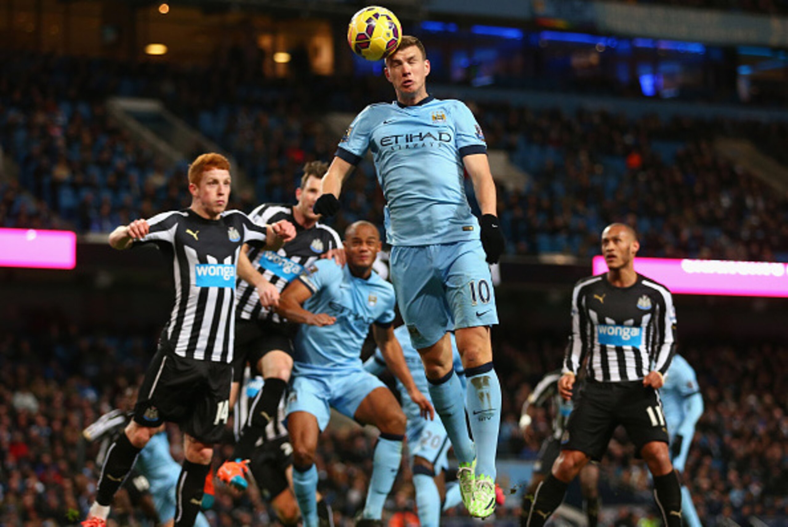 MANCHESTER, ENGLAND - FEBRUARY 21:  Edin Dzeko of Manchester City heads the ball during the Barclays Premier League match between Manchester City and Newcastle United at Etihad Stadium on February 21, 2015 in Manchester, England.  (Photo by Clive Brunskil