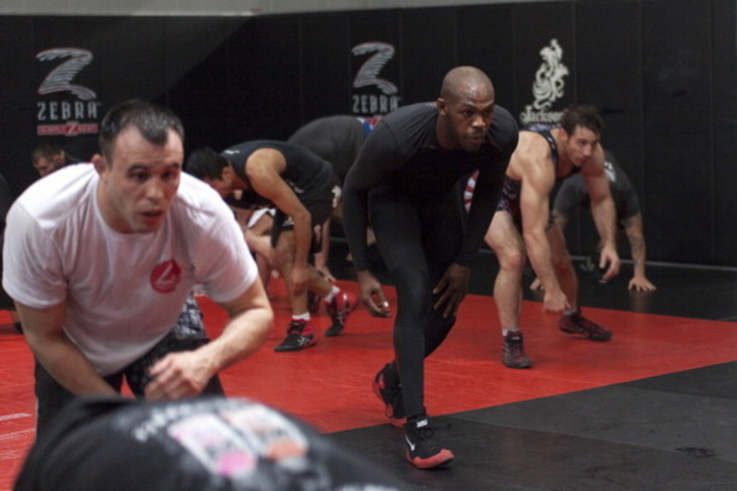 ALBUQUERQUE, NM - APRIL 2: UFC lightweight champion Jon 'Bones' Jones joins in for a warm up during an open training session for fans and media at the Jackson's Mixed Martial Arts and Fitness on April 2, 2014 in Albuquerque, New Mexico. (Photo by Aaron Sw ALBUQUERQUE, NM - APRIL 2: UFC lightweight champion Jon 'Bones' Jones joins in for a warm up during an open training session for fans and media at the Jackson's Mixed Martial Arts and Fitness on April 2, 2014 in Albuquerque, New Mexico. (Photo by Aaron Sw