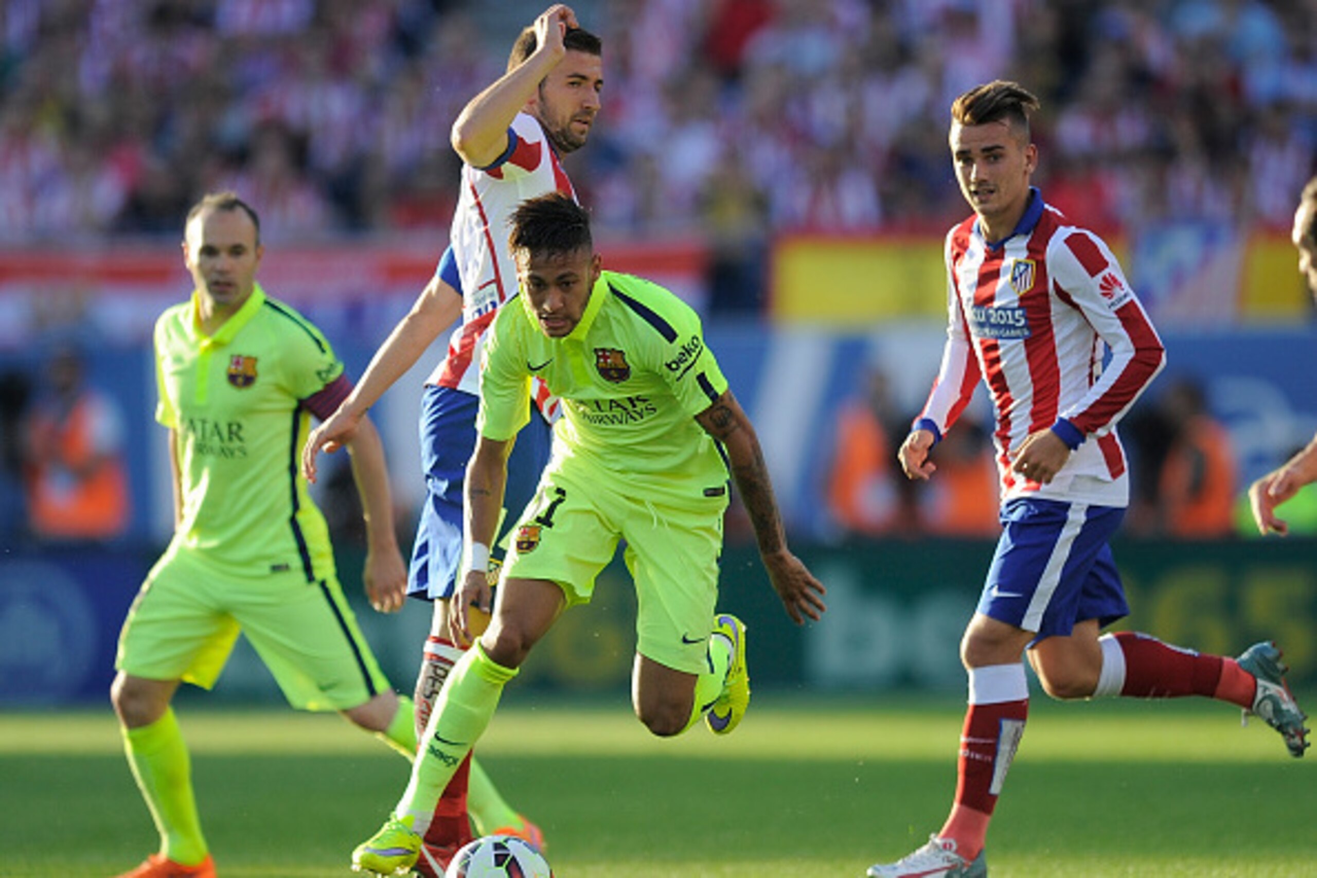 MADRID, SPAIN - MAY 17:  Neymar of FC Barcelona gets past Gabi Fernandez of Club Atletico de Madrid during the La Liga match between Club Atletico de Madrid and FC Barcelona at Vicente Calderon Stadium on May 17, 2015 in Madrid, Spain.  (Photo by Denis Do