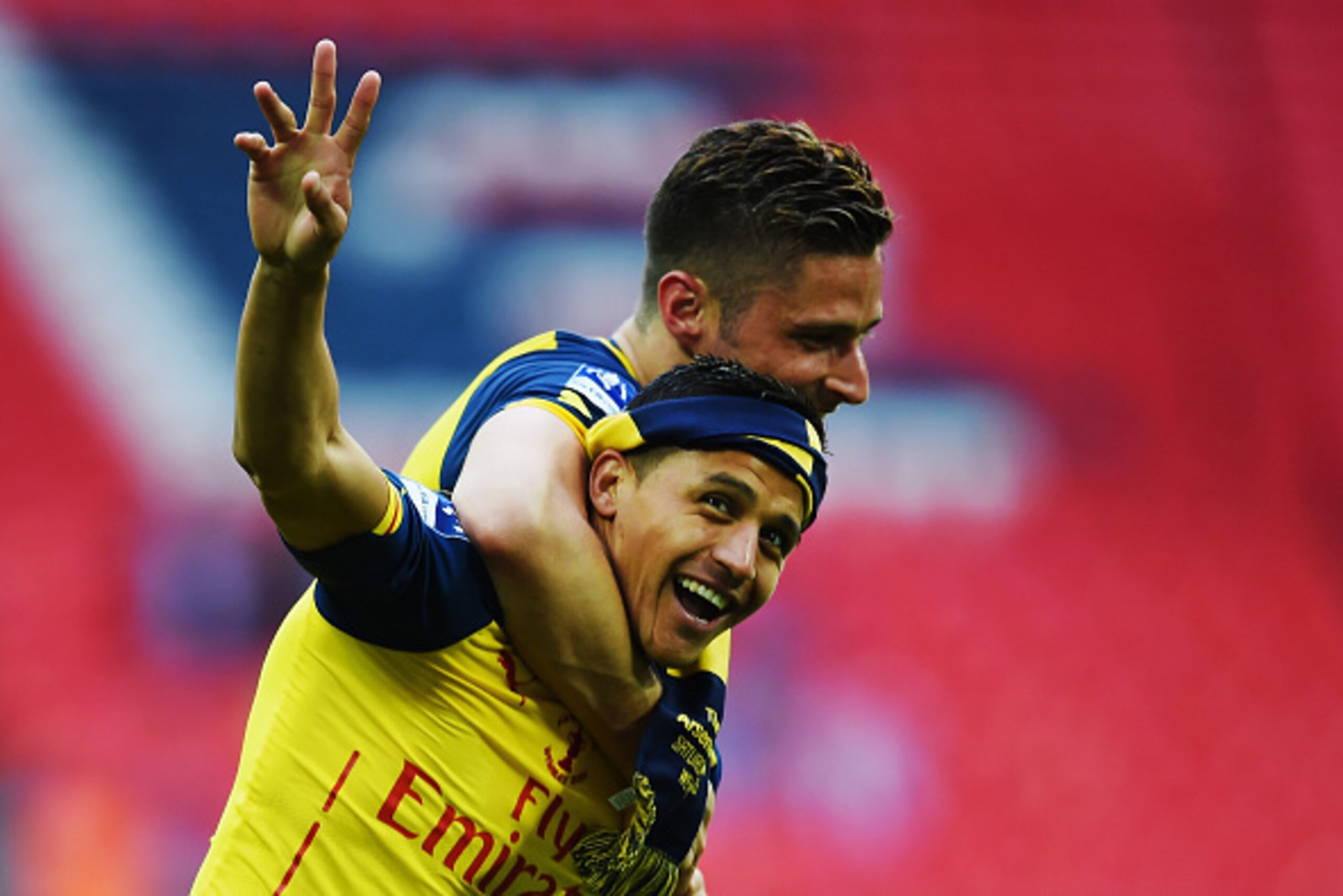 LONDON, ENGLAND - MAY 30:  Alexis Sanchez and Olivier Giroud of Arsenal celebrate victory after the FA Cup Final between Aston Villa and Arsenal at Wembley Stadium on May 30, 2015 in London, England. Arsenal beat Aston Villa 4-0.  (Photo by Shaun Botteril