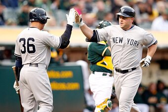 OAKLAND, CA - MAY 28:  Brian McCann #34 of the New York Yankees is congratulated by Carlos Beltran #36 after he hit a home run in the second inning against the Oakland Athletics at O.co Coliseum on May 28, 2015 in Oakland, California.  (Photo by Ezra Shaw
