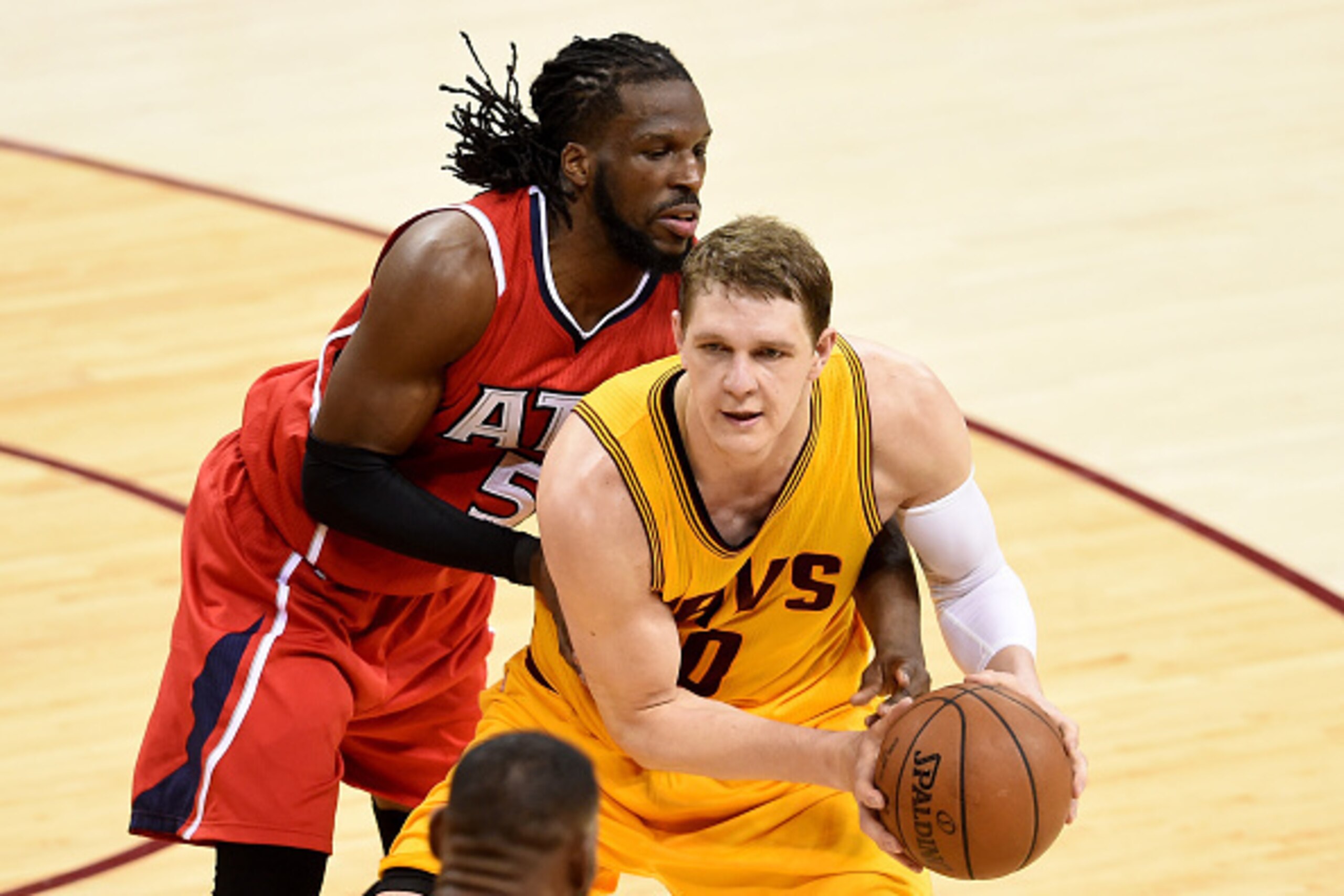 CLEVELAND, OH - MAY 26: Timofey Mozgov #20 of the Cleveland Cavaliers handles the ball against DeMarre Carroll #5 of the Atlanta Hawks in the third quarter during Game Four of the Eastern Conference Finals of the 2015 NBA Playoffs at Quicken Loans Arena o CLEVELAND, OH - MAY 26: Timofey Mozgov #20 of the Cleveland Cavaliers handles the ball against DeMarre Carroll #5 of the Atlanta Hawks in the third quarter during Game Four of the Eastern Conference Finals of the 2015 NBA Playoffs at Quicken Loans Arena o