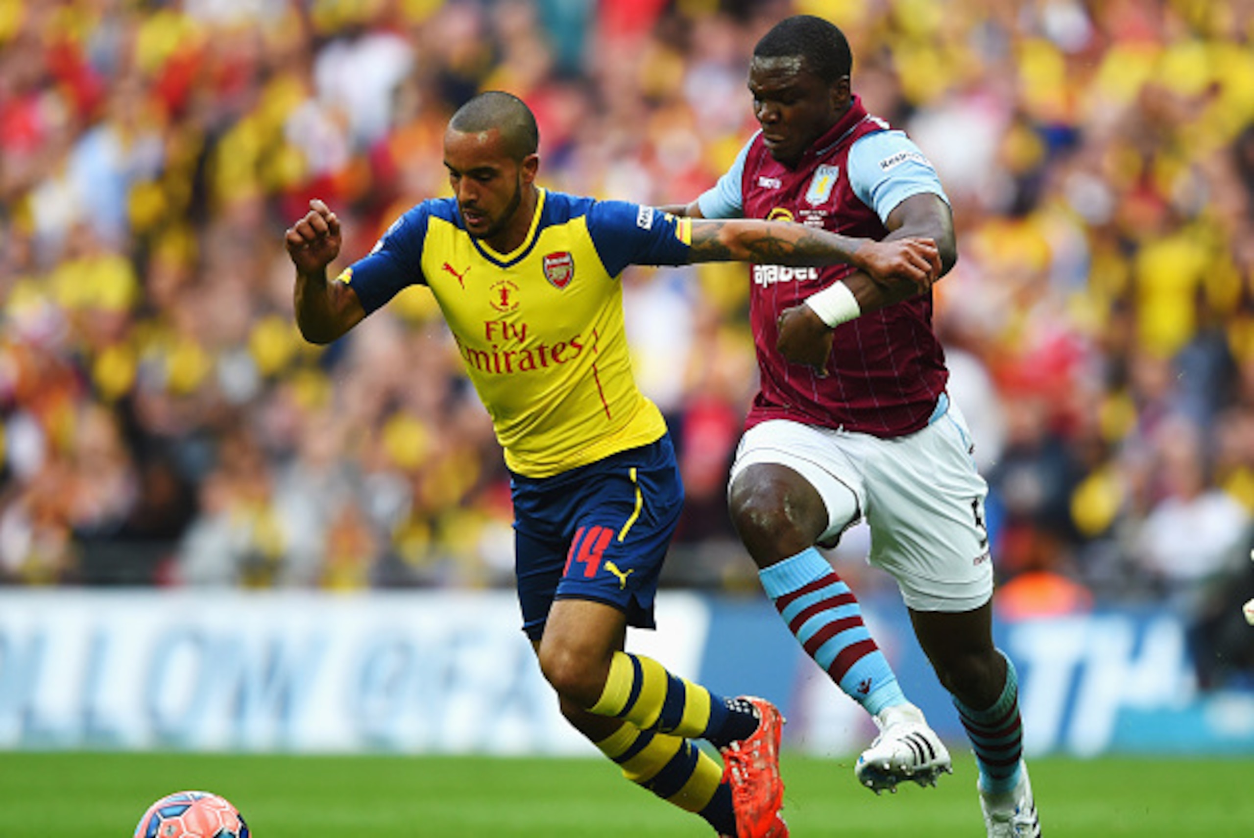 LONDON, ENGLAND - MAY 30:  Theo Walcott of Arsenal takes on Jores Okore of Aston Villa during the FA Cup Final between Aston Villa and Arsenal at Wembley Stadium on May 30, 2015 in London, England.  (Photo by Shaun Botterill/Getty Images)