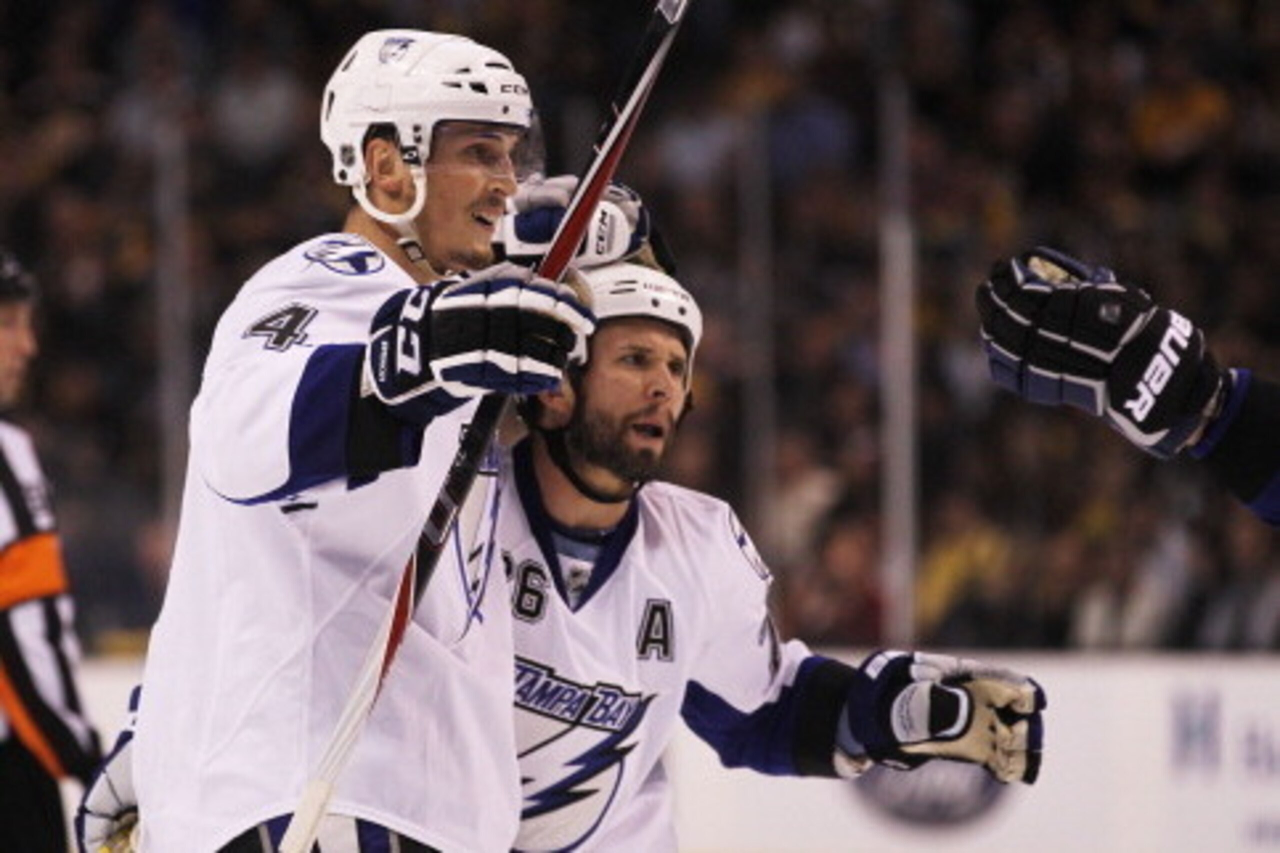 BOSTON, MA - MAY 17:  Vincent Lecavalier #4 celebrates with Martin St. Louis #26 of the Tampa Bay Lightning after Lecavalier scored a second period power play goal against the Boston Bruins in Game Two of the Eastern Conference Finals during the 2011 NHL 
