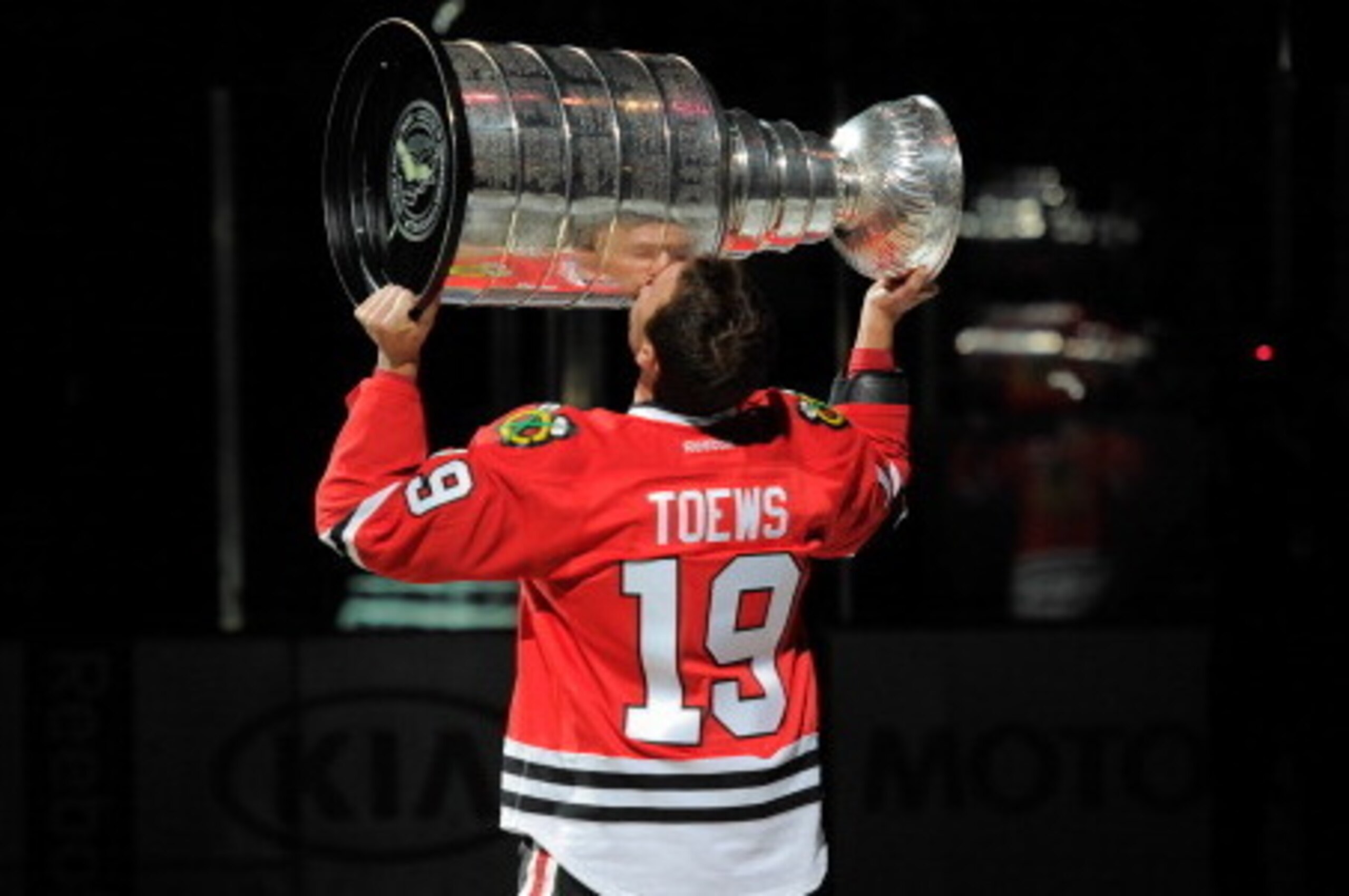CHICAGO, IL - OCTOBER 01:  Jonathan Toews #19 of the Chicago Blackhawks kisses the Stanley Cup during the opening ceremony before the home opener against the Washington Capitals on October 1, 2013 at the United Center in Chicago, Illinois. (Photo by Bill 