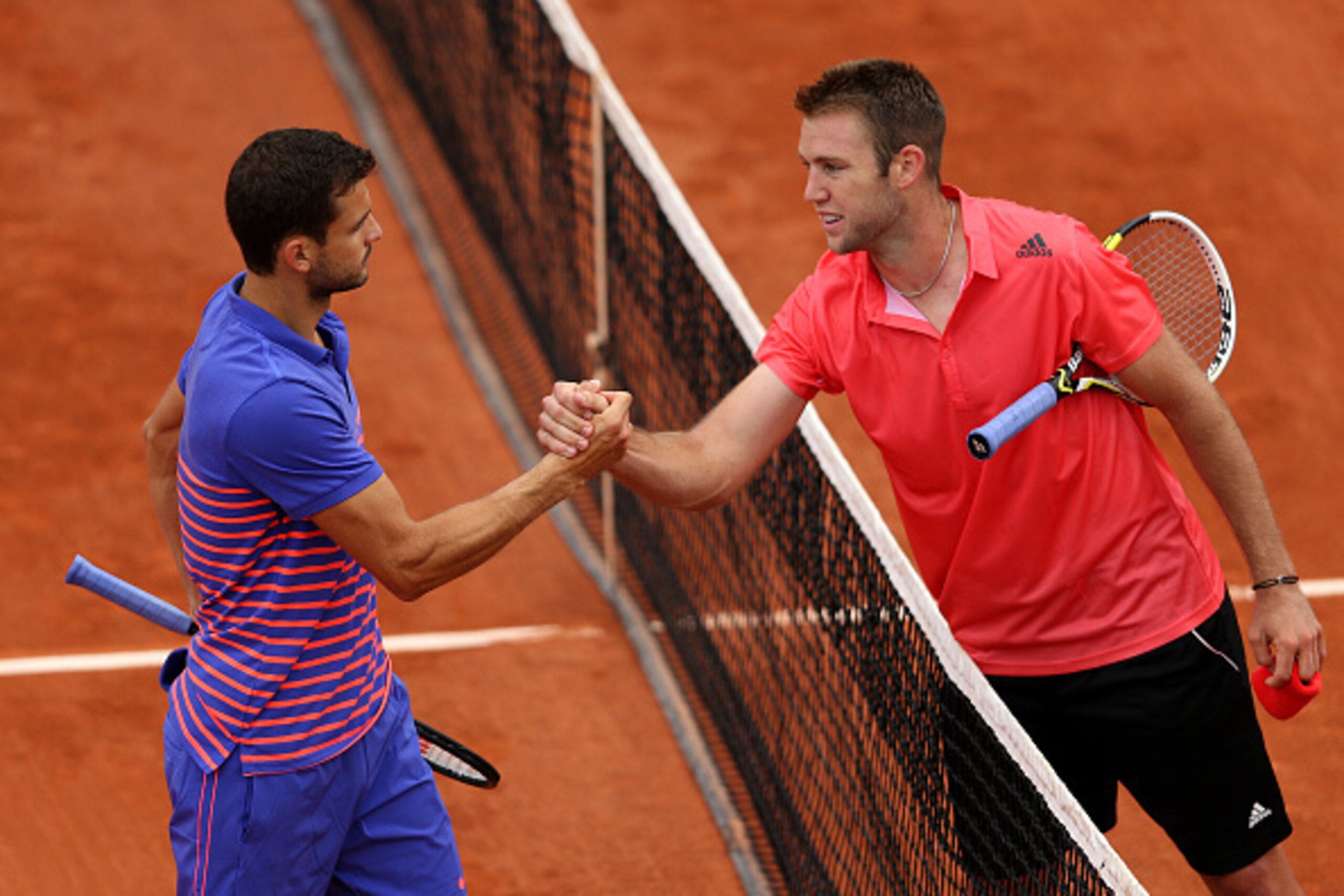 PARIS, FRANCE - MAY 26: Jack Sock of the United States is congratulated on victory at the net by Grigor Dimitrov of Bulgaria after their Men's Singles match on day three of the 2015 French Open at Roland Garros on May 26, 2015 in Paris, France. (Photo b PARIS, FRANCE - MAY 26: Jack Sock of the United States is congratulated on victory at the net by Grigor Dimitrov of Bulgaria after their Men's Singles match on day three of the 2015 French Open at Roland Garros on May 26, 2015 in Paris, France. (Photo b
