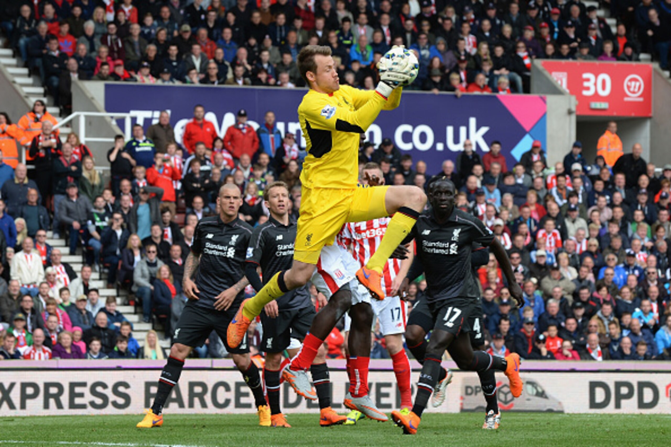 STOKE ON TRENT, ENGLAND - MAY 24: Simon Mignolet of Liverpool gathers the ball during the Barclays Premier League match between Stoke City and Liverpool at Britannia Stadium on May 24, 2015 in Stoke on Trent, England. (Photo by Tony Marshall/Getty Images STOKE ON TRENT, ENGLAND - MAY 24: Simon Mignolet of Liverpool gathers the ball during the Barclays Premier League match between Stoke City and Liverpool at Britannia Stadium on May 24, 2015 in Stoke on Trent, England. (Photo by Tony Marshall/Getty Images