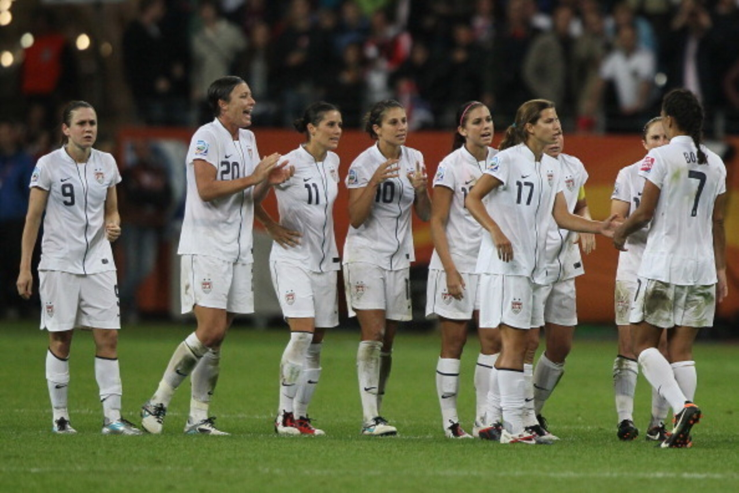FRANKFURT AM MAIN, GERMANY - JULY 17: Tobin Heath of USA (3rd R) comforts Sahnnon Boxx of USA (R) after failed shooting a penalty during the FIFA Women's World Cup Final match between Japan and USA at the FIFA World Cup stadium Frankfurt on July 17, 2011 