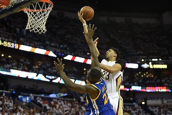 NEW ORLEANS, LA - APRIL 25:  Anthony Davis #23 of the New Orleans Pelicans drives to the basket against Draymond Green #23 of the Golden State Warriors during Game Four in the first round of the 2015 NBA Playoffs at the Smoothie King Center on April 25, 2