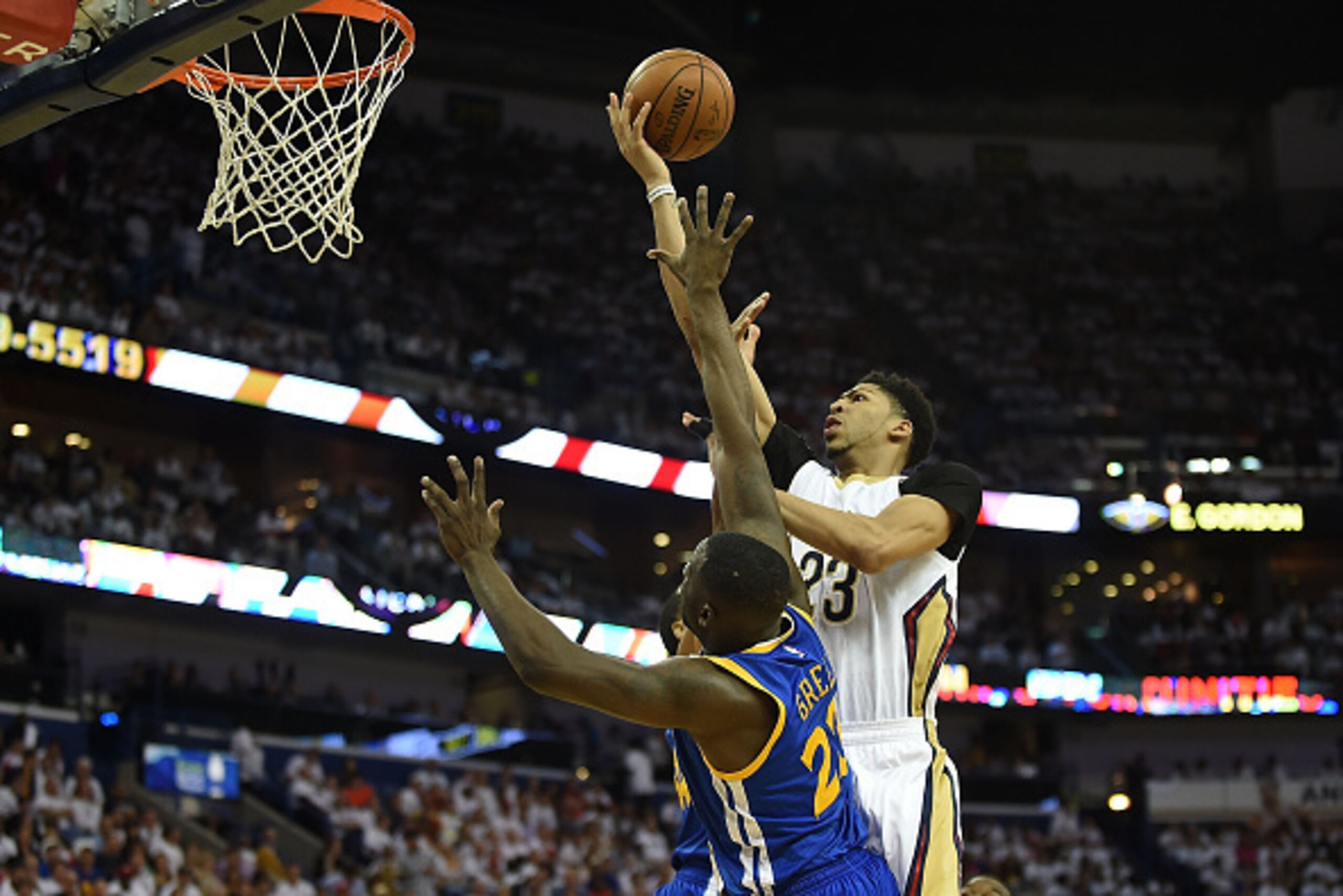 NEW ORLEANS, LA - APRIL 25:  Anthony Davis #23 of the New Orleans Pelicans drives to the basket against Draymond Green #23 of the Golden State Warriors during Game Four in the first round of the 2015 NBA Playoffs at the Smoothie King Center on April 25, 2