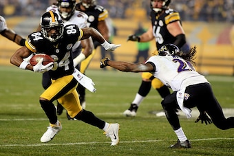 PITTSBURGH, PA - JANUARY 03:  Antonio Brown #84 of the Pittsburgh Steelers avoids a tackle by  Lardarius Webb #21 of the Baltimore Ravens during their AFC Wild Card game at Heinz Field on January 3, 2015 in Pittsburgh, Pennsylvania.  (Photo by Justin K. A