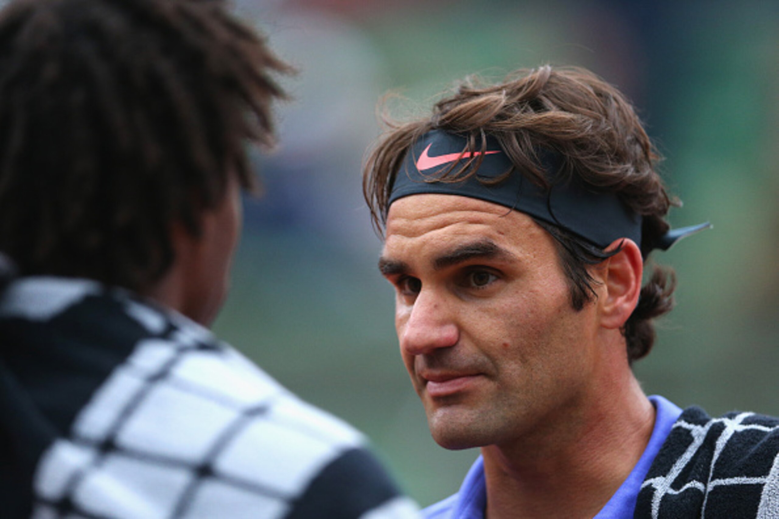 PARIS, FRANCE - MAY 31:  Roger Federer of Switzerland talks to Gael Monfils of France as play is suspended after the second set due to bad light during their Men's Singles match on day eight of the 2015 French Open at Roland Garros on May 31, 2015 in Pari