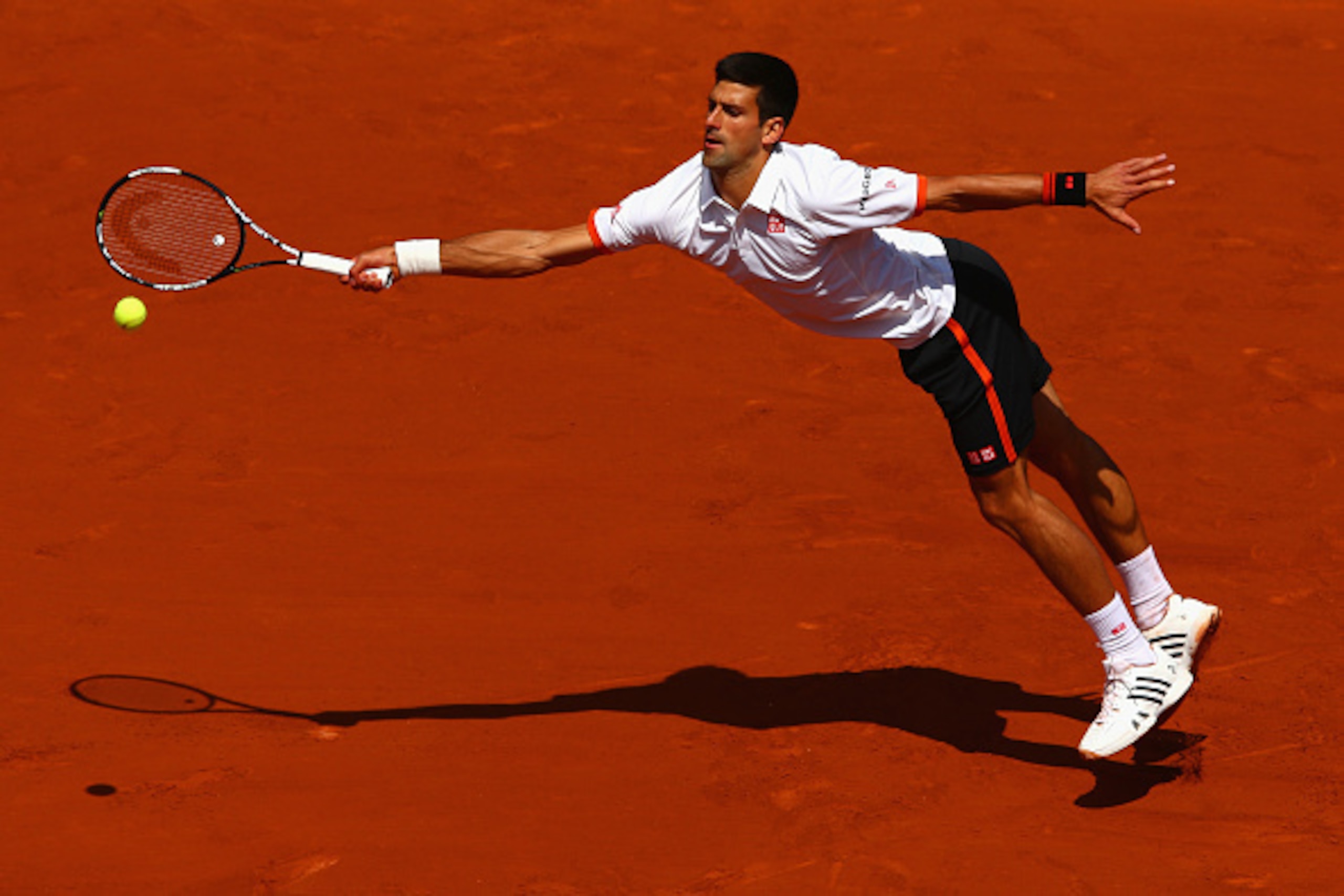 PARIS, FRANCE - MAY 30:  Novak Djokovic of Serbia stretches for a forehand in his Men's Singles match against Thanasi Kokkinakis of Australia on day seven of the 2015 French Open at Roland Garros on May 30, 2015 in Paris, France.  (Photo by Clive Mason/Ge