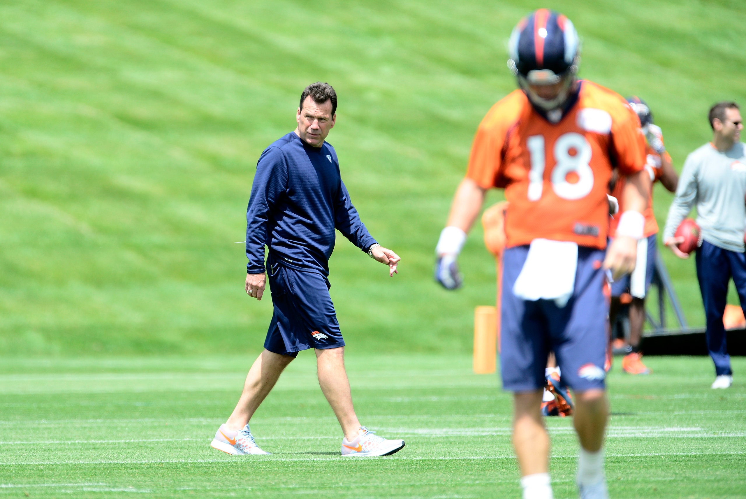 May 27, 2015; Englewood, CO, USA; Denver Broncos head coach Gary Kubiak walks the field past quarterback Peyton Manning (18) before the start of organized team activities at the Broncos training facility. Mandatory Credit: Ron Chenoy-USA TODAY Sports May 27, 2015; Englewood, CO, USA; Denver Broncos head coach Gary Kubiak walks the field past quarterback Peyton Manning (18) before the start of organized team activities at the Broncos training facility. Mandatory Credit: Ron Chenoy-USA TODAY Sports