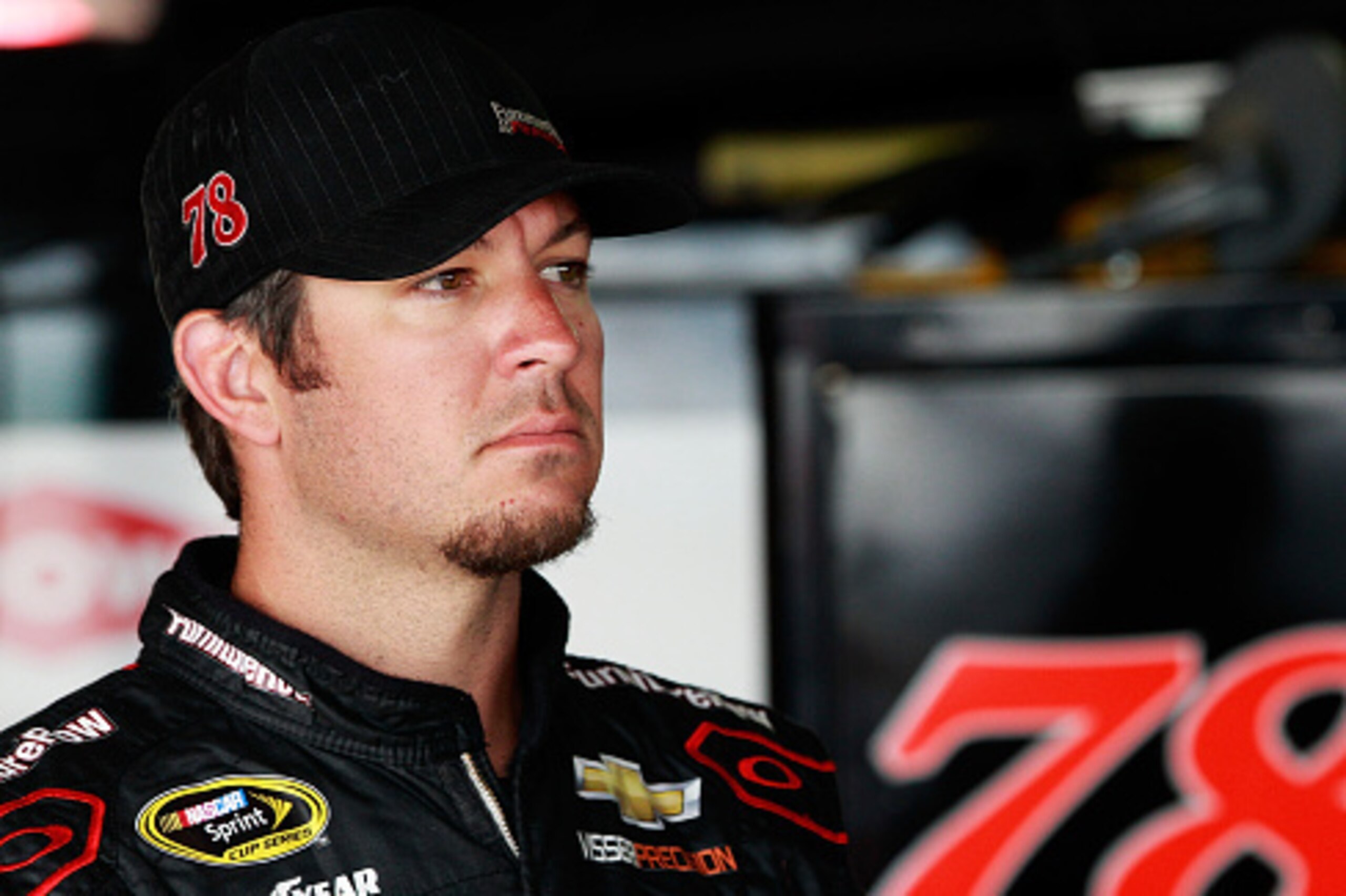 DOVER, DE - MAY 29: Martin Truex Jr., driver of the #78 Furniture Row/Visser Precision Chevrolet, looks on in the garage area during practice for the NASCAR Sprint Cup Series FedEx 400 Benefiting Autism Speaks at Dover International Speedway on May 29, 2 DOVER, DE - MAY 29: Martin Truex Jr., driver of the #78 Furniture Row/Visser Precision Chevrolet, looks on in the garage area during practice for the NASCAR Sprint Cup Series FedEx 400 Benefiting Autism Speaks at Dover International Speedway on May 29, 2
