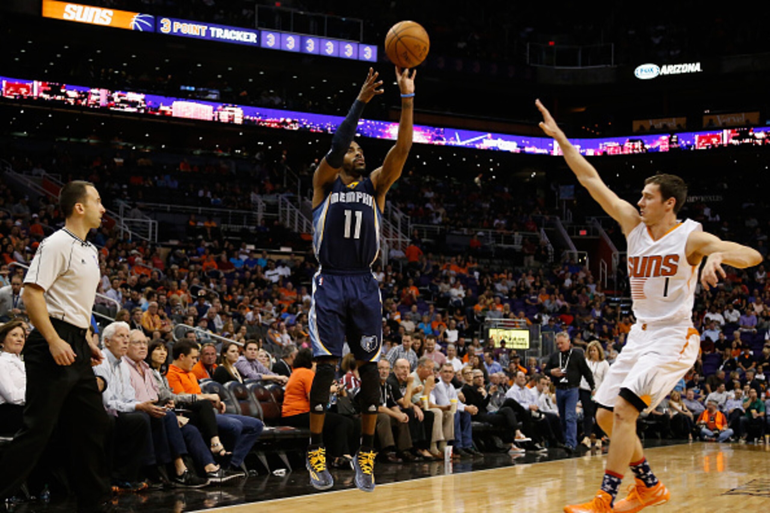 PHOENIX, AZ - NOVEMBER 05:  Mike Conley #11 of the Memphis Grizzlies puts up a three point shot over Goran Dragic #1 of the Phoenix Suns during the second half of the NBA game at US Airways Center on November 5, 2014 in Phoenix, Arizona.  The Grizzlies de