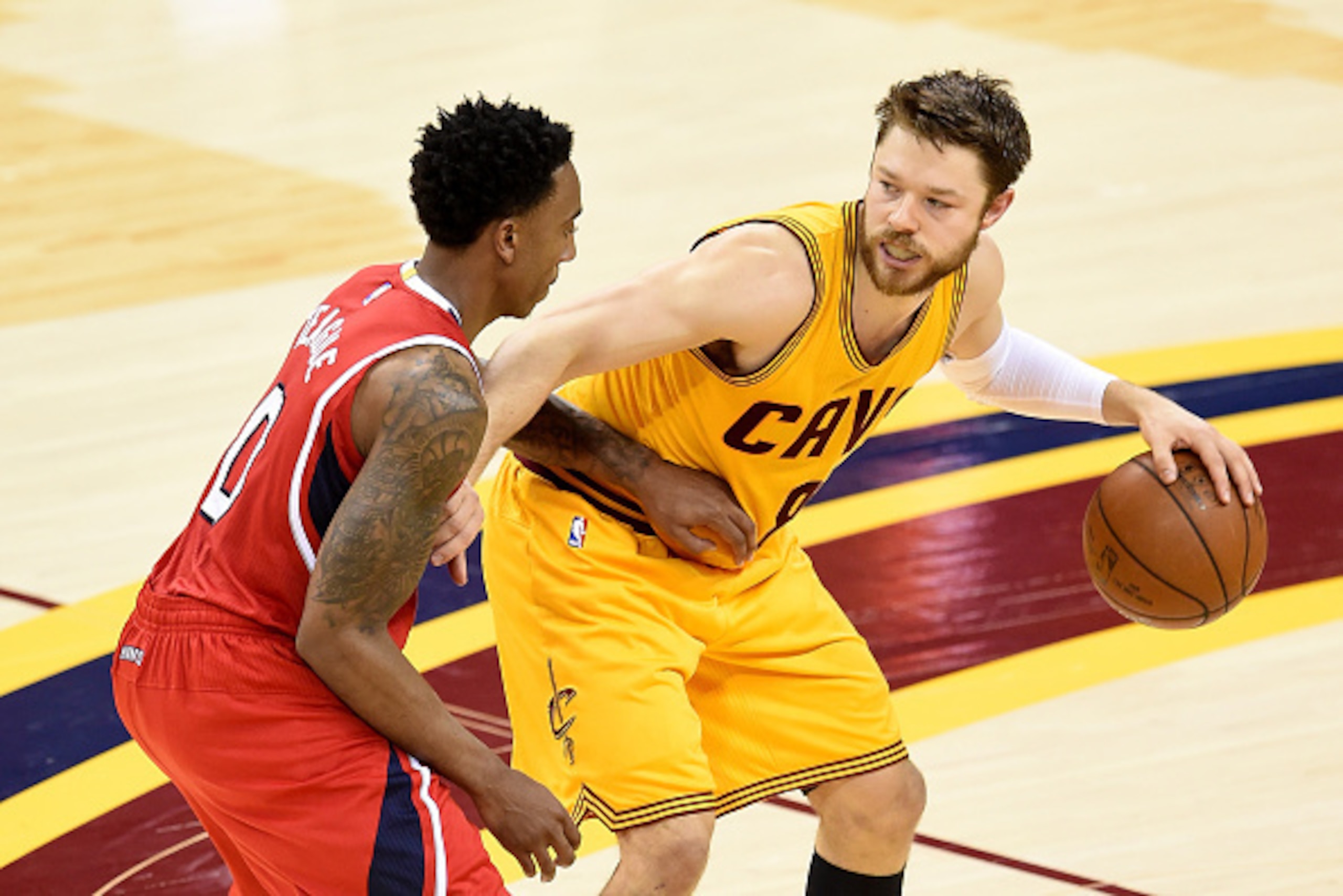 CLEVELAND, OH - MAY 26: Matthew Dellavedova #8 of the Cleveland Cavaliers handles the ball against Jeff Teague #0 of the Atlanta Hawks in the second quarter during Game Four of the Eastern Conference Finals of the 2015 NBA Playoffs at Quicken Loans Arena 