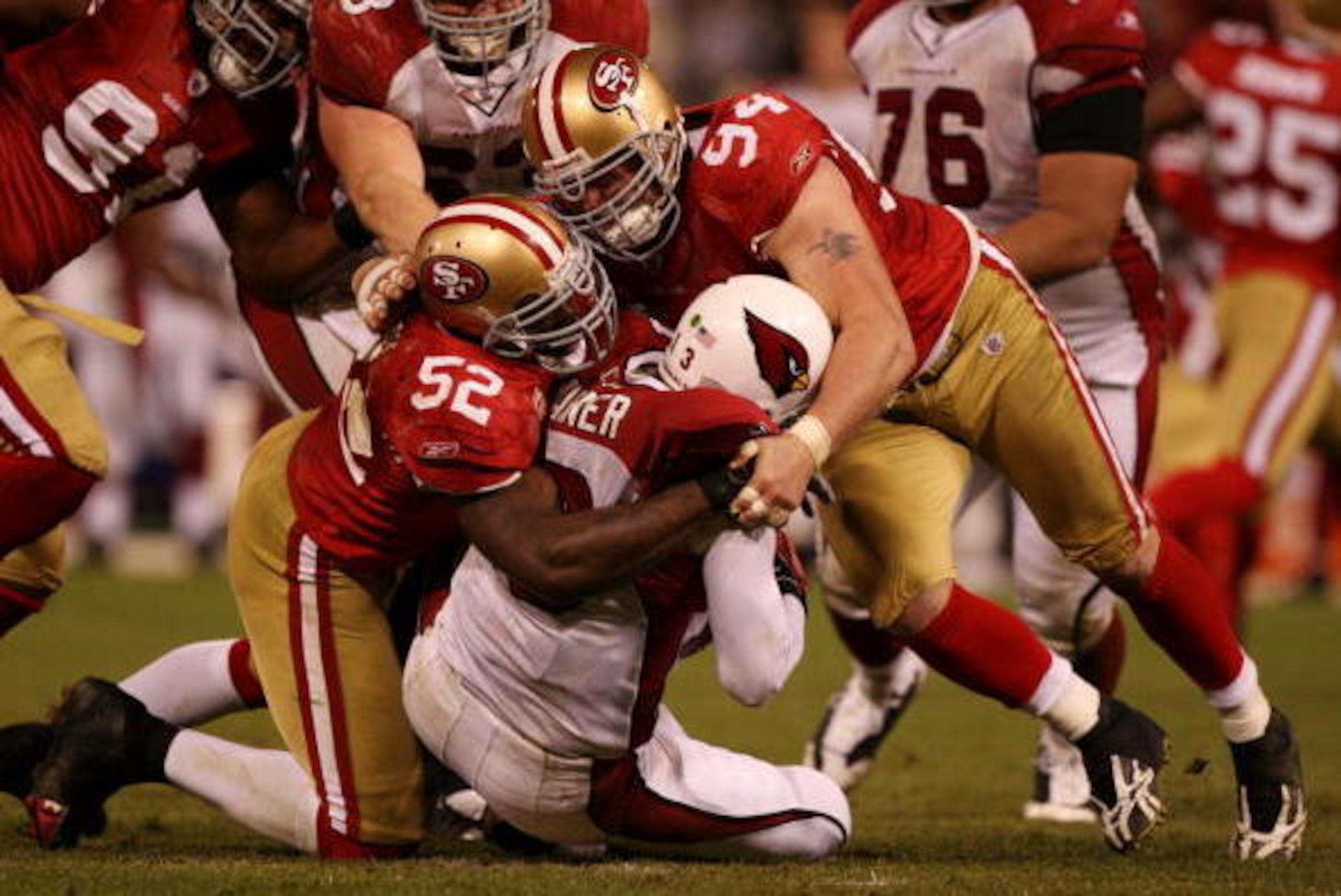 SAN FRANCISCO - DECEMBER 14:  Kurt Warner #13 of the Arizona Cardinals is sacked by Patrick Willis #52 and Justin Smith #94 of the San Francisco 49ers in the fourth quarter at Candlestick Park on December 14, 2009 in San Francisco, California. (Photo by J