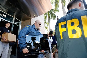 MIAMI BEACH, FL - MAY 27:  FBI agents carry boxes and computers from the headquarters of CONCACAF after it was raided on May 27, 2015 in Miami Beach, Florida. The raid is part of an international investigation of FIFA where nine FIFA officials and five co