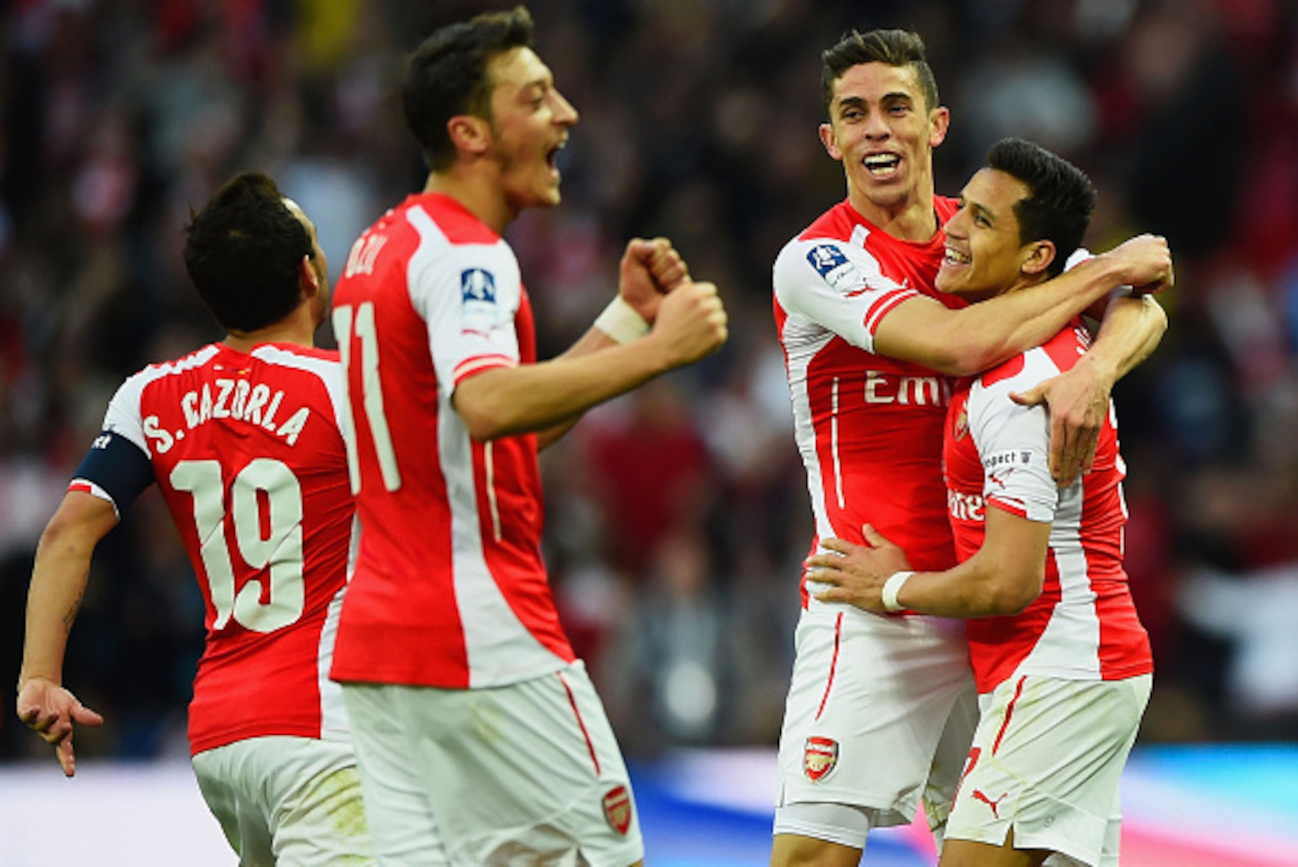 LONDON, ENGLAND - APRIL 18:  Alexis Sanchez of Arsenal (R) celebrates with Santi Cazorla (L), Mesut Oezil (2L) and Gabriel (2R) as he scores their second goal during the FA Cup Semi Final between Arsenal and Reading at Wembley Stadium on April 18, 2015 in