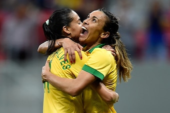BRASILIA, BRAZIL - DECEMBER 10:  Marta (R) and Andressa of Brazil celebrate the victory against Argentina during a match between Brazil and Argentina as part of International Women's Football Tournament of Brasilia at Mane Garrincha Stadium on December 10