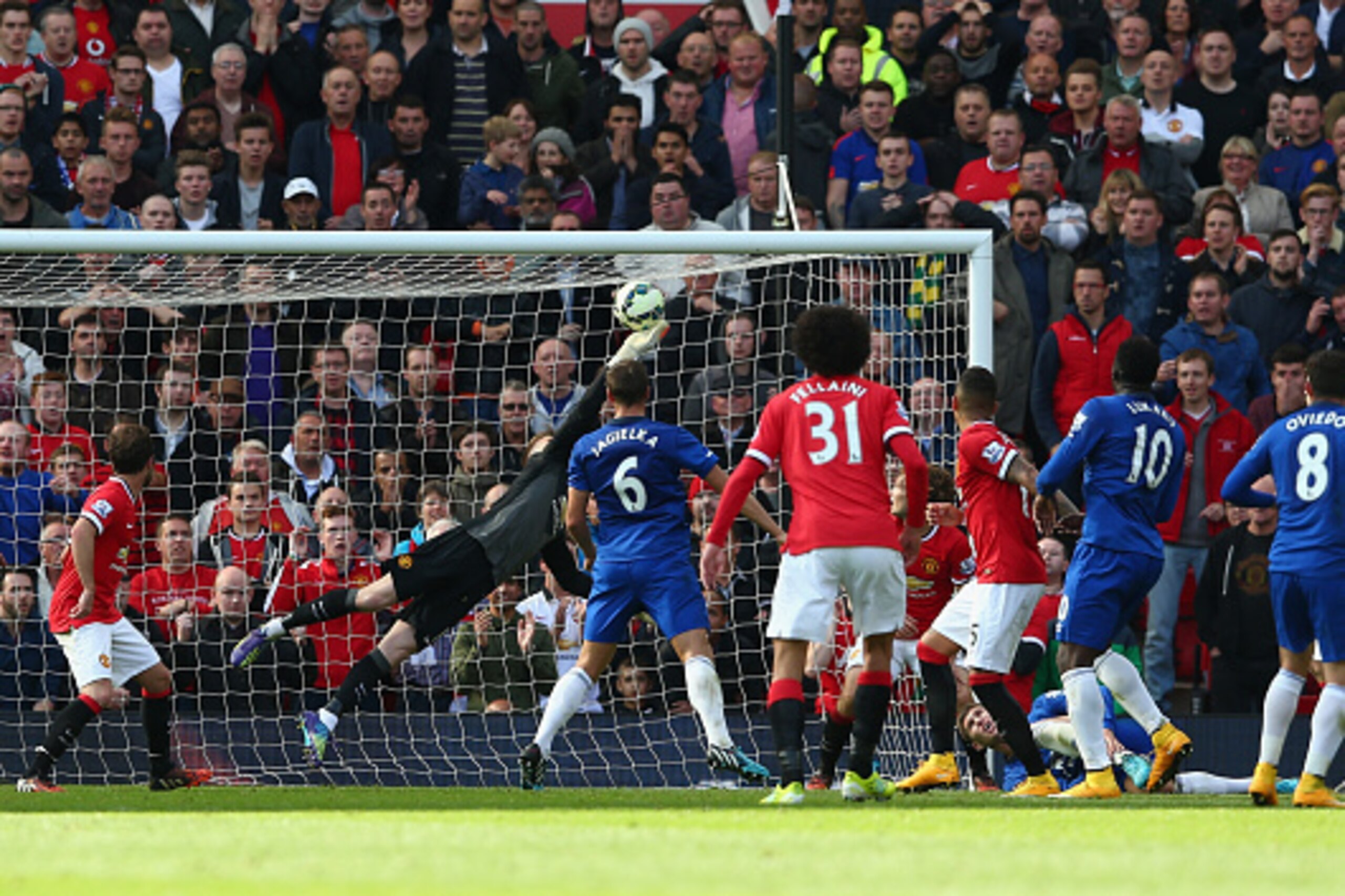 MANCHESTER, ENGLAND - OCTOBER 05:  David De Gea of Manchester United saves the shot of Bryan Oviedo of Everton during the Barclays Premier League match between Manchester United and Everton at Old Trafford on October 5, 2014 in Manchester, England.  (Phot