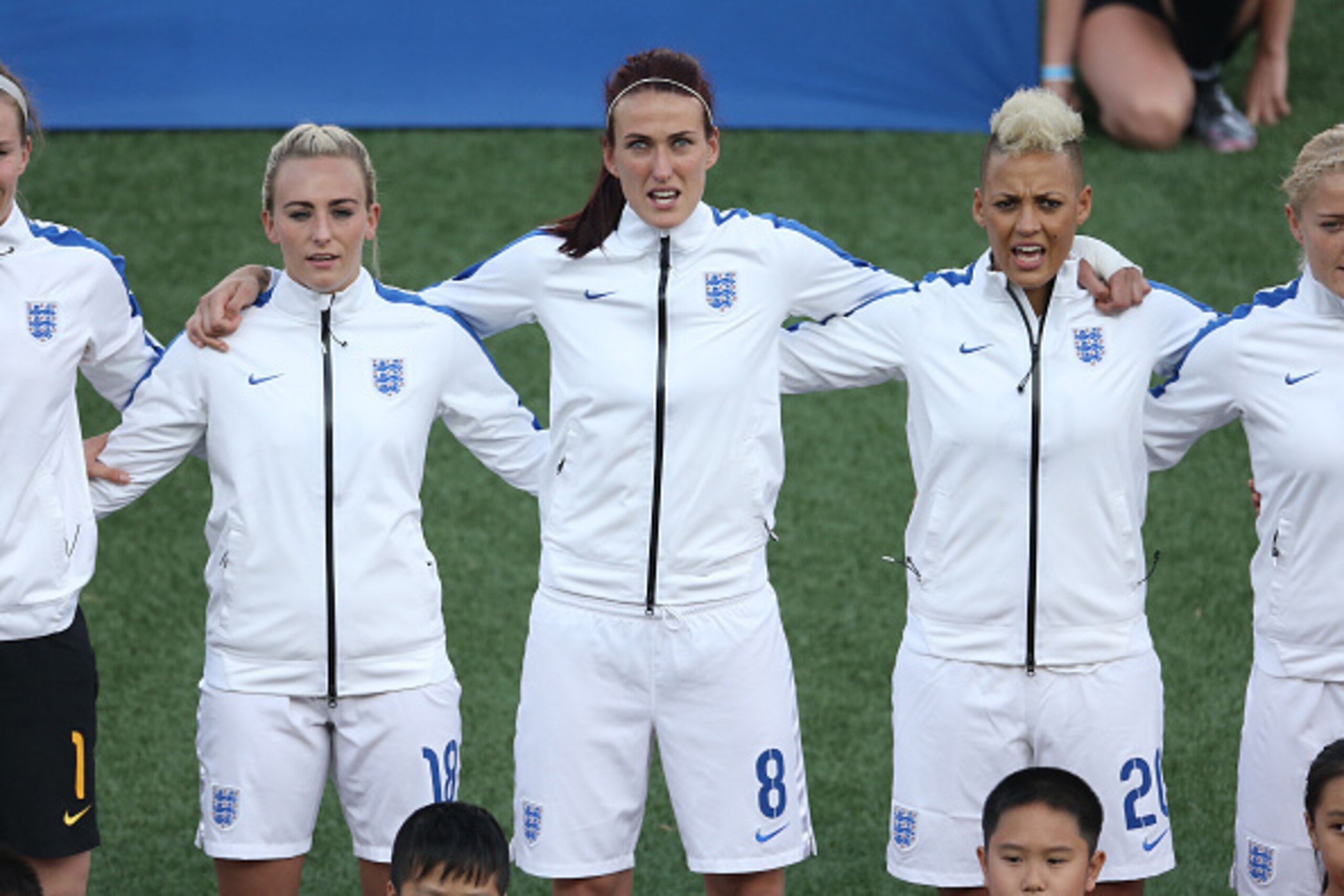 HAMILTON, CANADA - MAY 29: Toni Duggan #18 of England and Jill Scott #8 and Lianne Sanderson #20 stand for the playing of the English anthem before the start of their match against Canada during their Womenâs International Friendly match on May 29, 2015 a