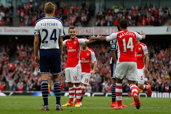 LONDON, ENGLAND - MAY 24: Jack Wilshere (2nd L) of Arsenal celbrates scoring his team's third goal with his team mate Theo Walcott during the Barclays Premier League match between Arsenal and West Bromwich Albion at Emirates Stadium on May 24, 2015 in Lon