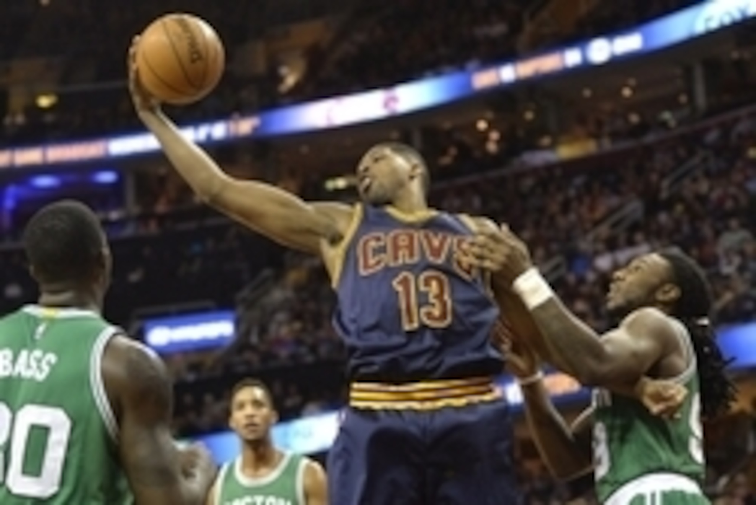 Mar 3, 2015; Cleveland, OH, USA; Cleveland Cavaliers center Tristan Thompson (13) rebounds between Boston Celtics center Brandon Bass (30) and forward Jae Crowder (99) in the first quarter at Quicken Loans Arena. Mandatory Credit: David Richard-USA TODAY 