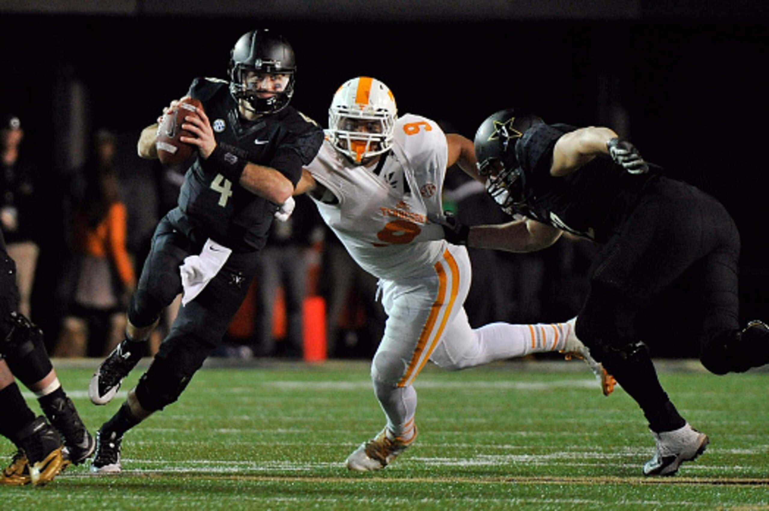 NASHVILLE, TN - NOVEMBER 29:  Quarterback Patton Robinette #4 of the Vanderbilt Commoroders is pressured  by Derek Barnett #9 of the Tennessee Volunteers during the second half of a game  at Vanderbilt Stadium on November 29, 2014 in Nashville, Tennessee.