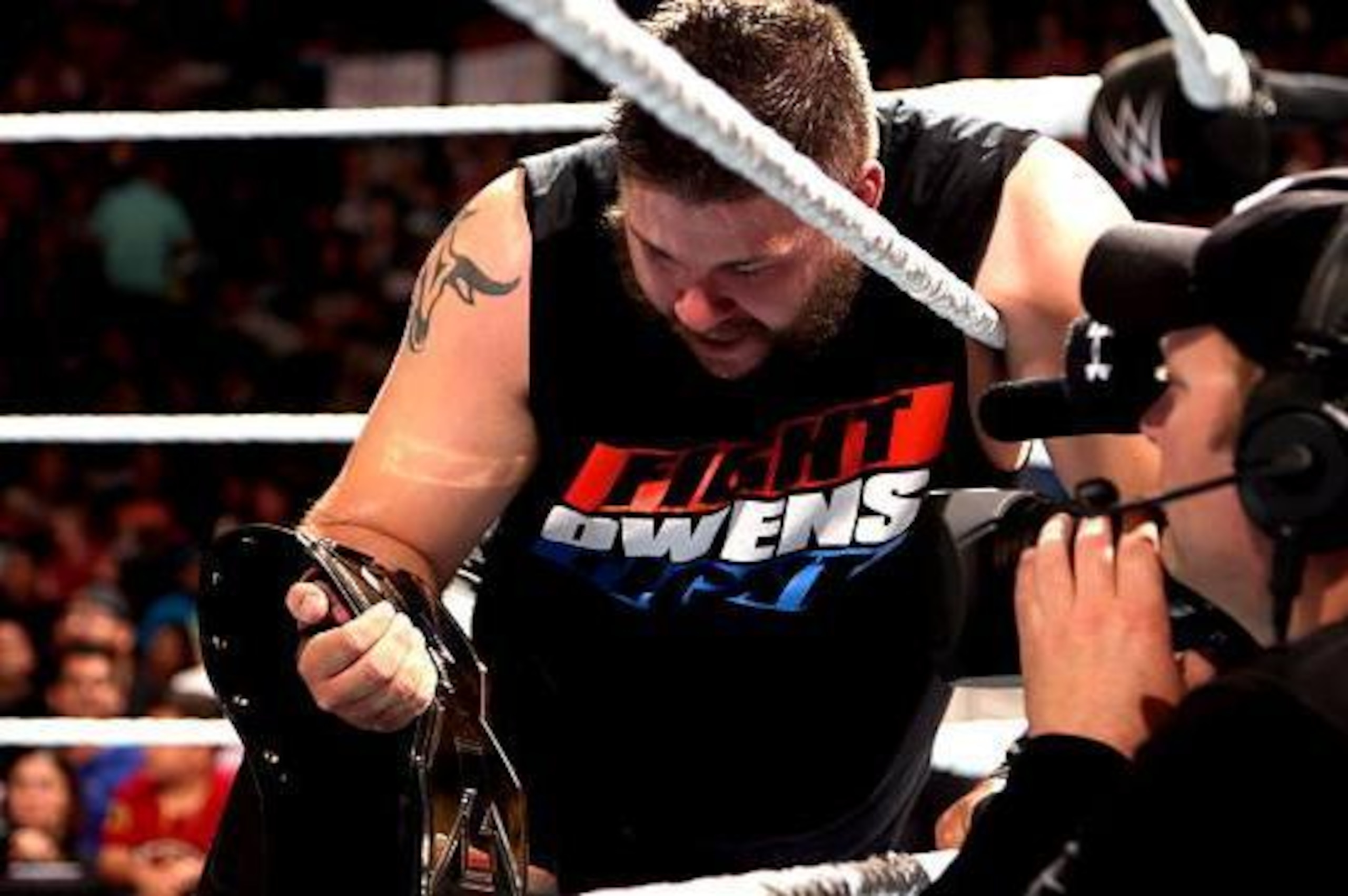 Kevin Owens celebrates his win.