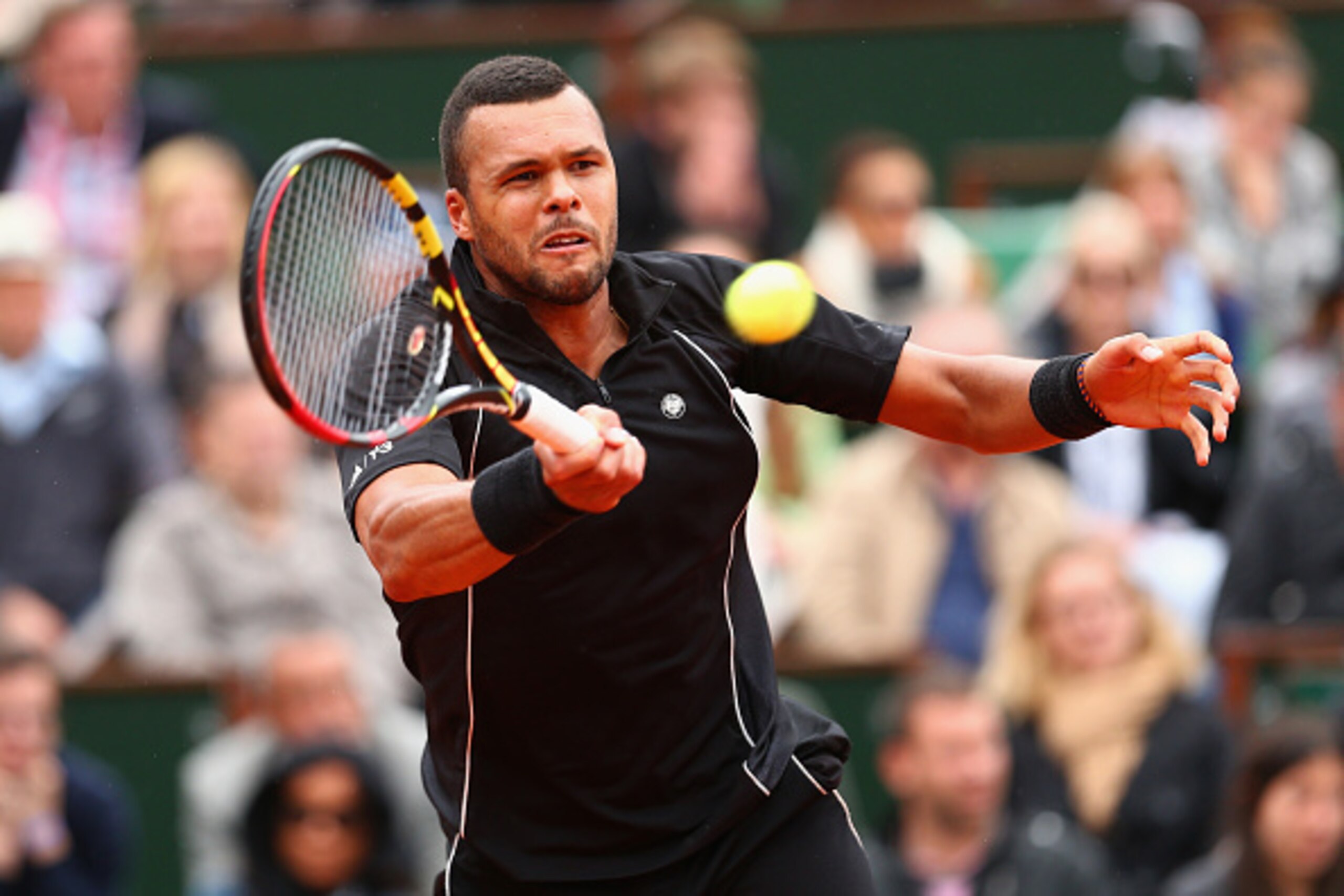 PARIS, FRANCE - MAY 31:  Jo-Wilfried Tsonga of France plays a forehand in his Men's Singles match against Tomas Berdych of Czech Republic on day eight of the 2015 French Open at Roland Garros on May 31, 2015 in Paris, France.  (Photo by Clive Brunskill/Ge
