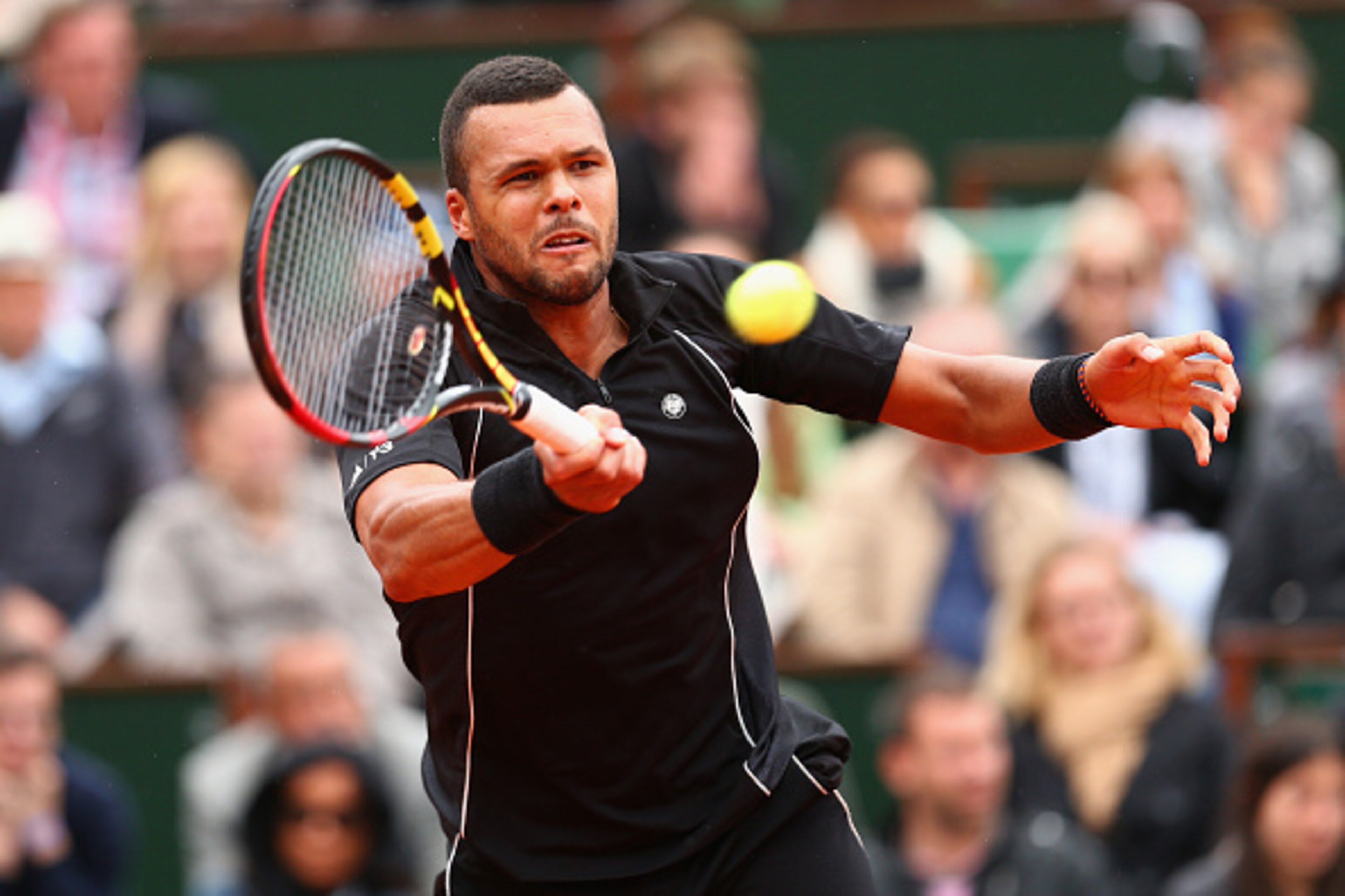 PARIS, FRANCE - MAY 31:  Jo-Wilfried Tsonga of France plays a forehand in his Men's Singles match against Tomas Berdych of Czech Republic on day eight of the 2015 French Open at Roland Garros on May 31, 2015 in Paris, France.  (Photo by Clive Brunskill/Ge