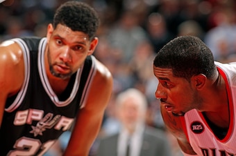 PORTLAND, OR - FEBRUARY 25:  Tim Duncan #21 of the San Antonio Spurs and LaMarcus Aldridge #12 of the Portland Trail Blazers during the game on February 25, 2015 at the Moda Center Arena in Portland, Oregon. NOTE TO USER: User expressly acknowledges and a