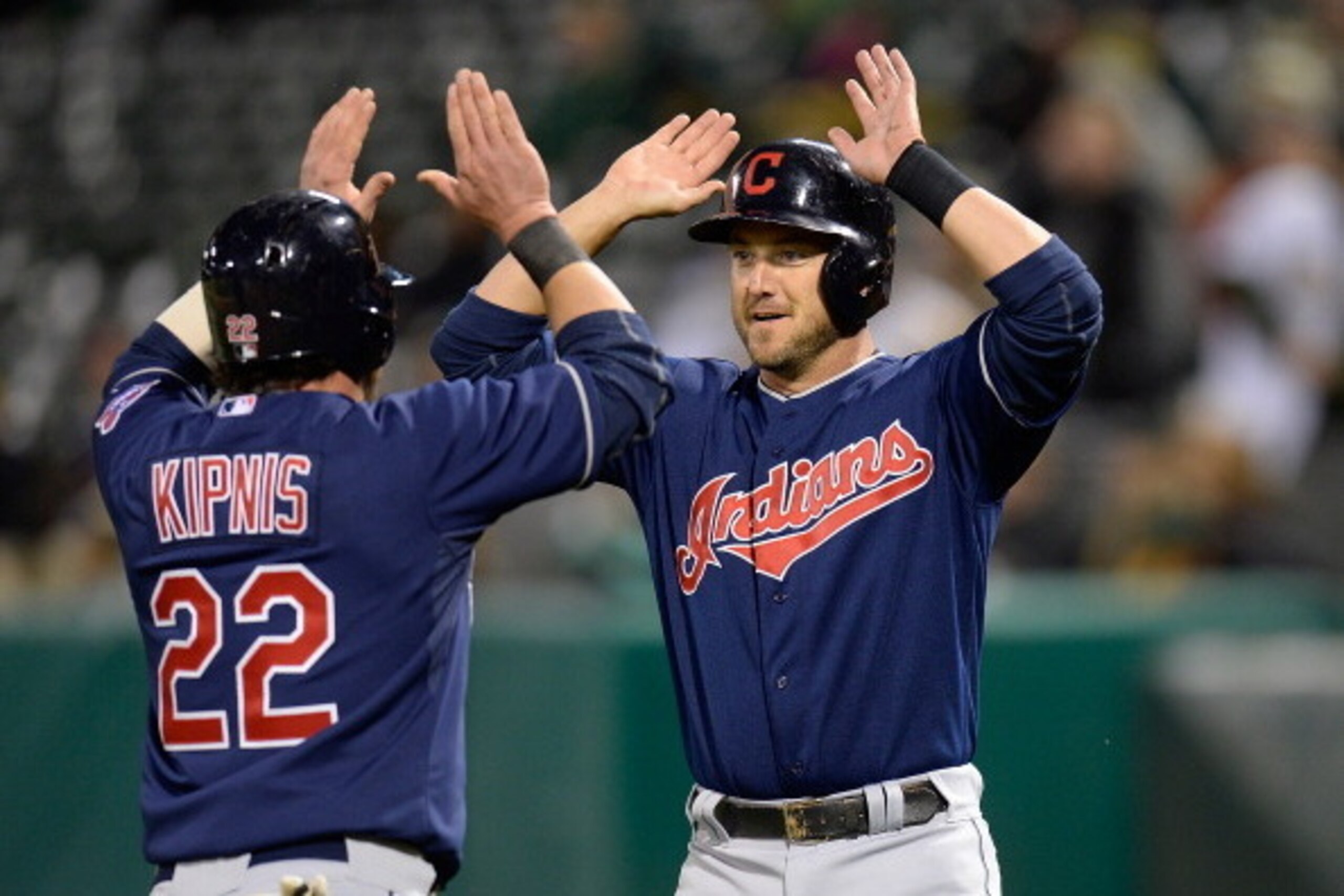 OAKLAND, CA - APRIL 02:  Ryan Raburn #9 and Jason Kipnis #22 of the Cleveland Indians celebrates after they both scored on a two-run single from Michael Brantley #23 (not pictured) against the Oakland Athletics in the top of the ninth inning at O.co Colis