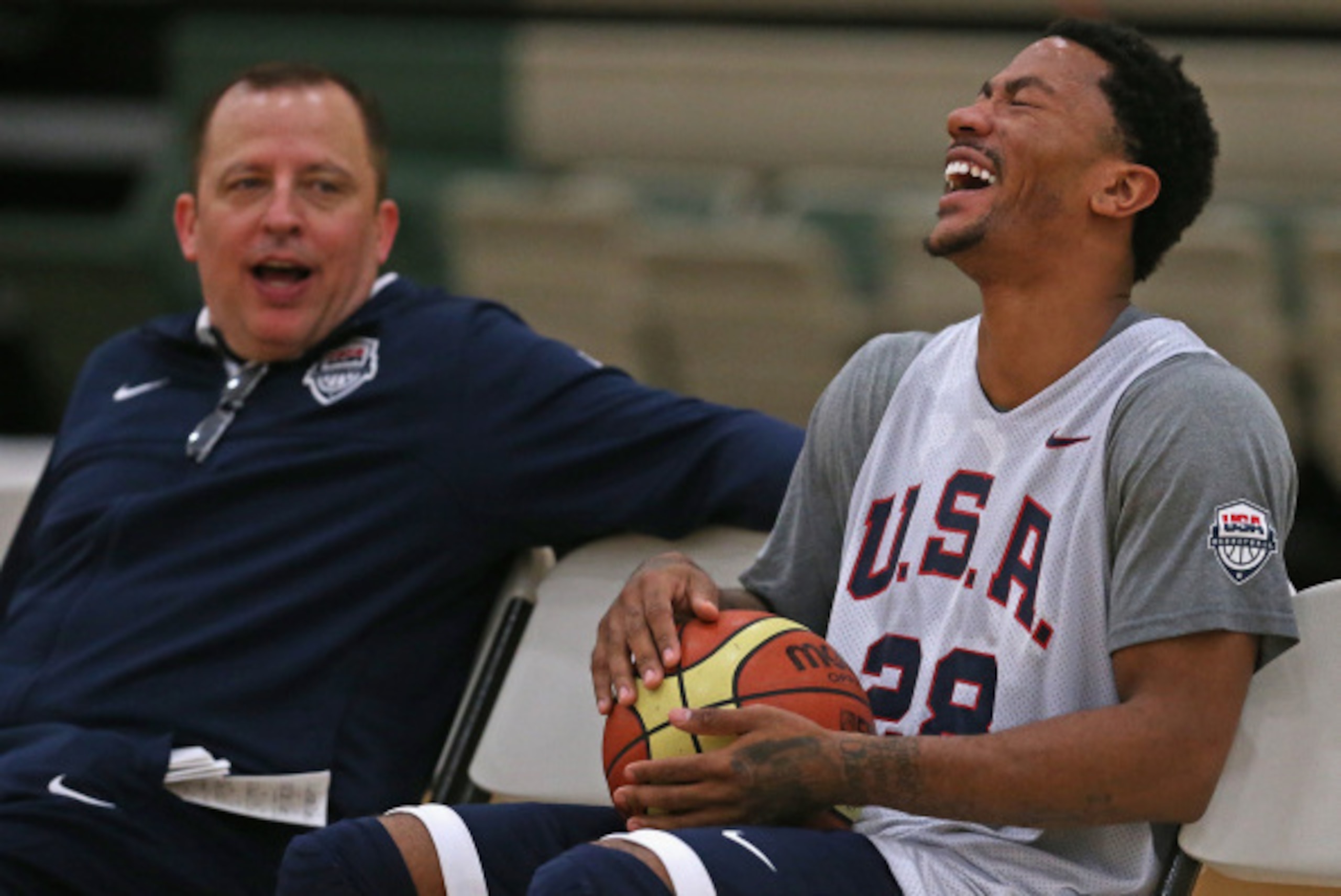 CHICAGO, IL - AUGUST 15:  Derrick Rose, wearing #28, laughs at a story told by assistant USA coach and his head coach of the Chicago Bulls, Tom Thibodeau, during a USA basketball training session at Quest MultiSport Complex on August 15, 2014 in Chicago, 