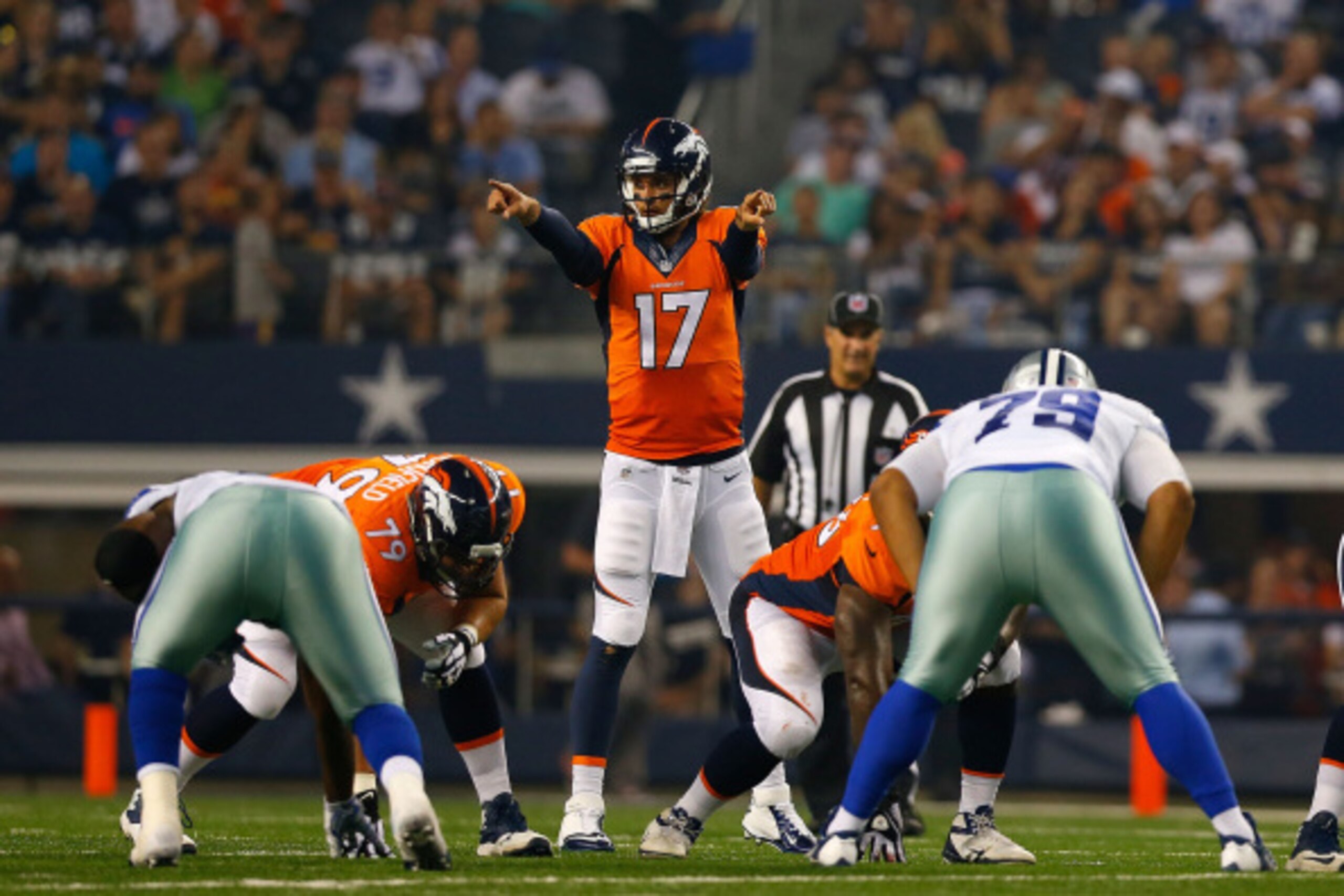 ARLINGTON, TX - AUGUST 28:  Brock Osweiler #17 of the Denver Broncos directs the Denver offense in the first half of their preseason game against the Dallas Cowboys at AT&T Stadium on August 28, 2014 in Arlington, Texas.  (Photo by Tom Pennington/Getty Im