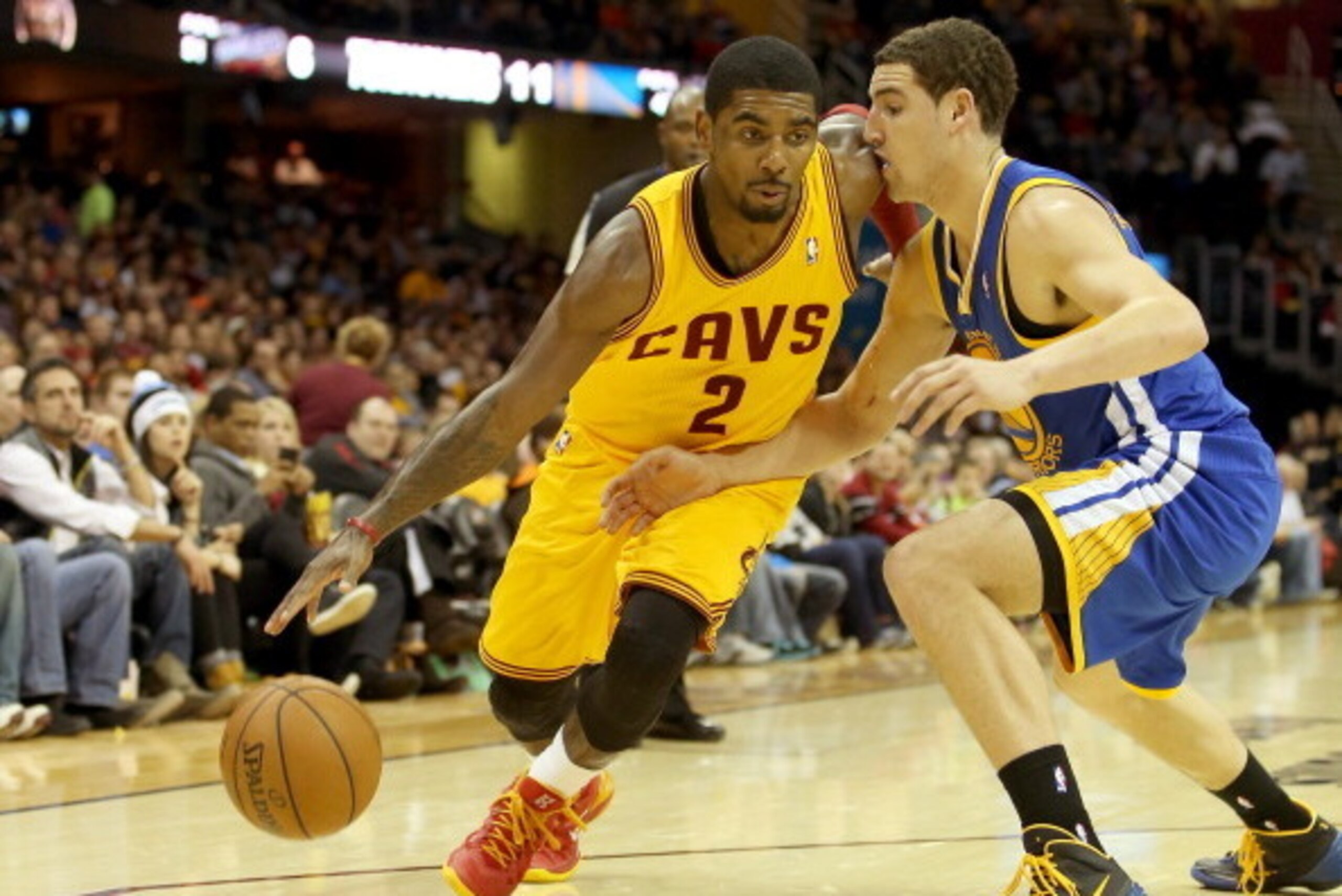 CLEVELAND, OH - DECEMBER 29: Kyrie Irving #2 of the Cleveland Cavaliers handles the ball against Klay Thompson #11 of the Golden State Warriors in the third quarter at Quicken Loans Arena on December 29, 2013 in Cleveland, Ohio. NOTE TO USER: User express