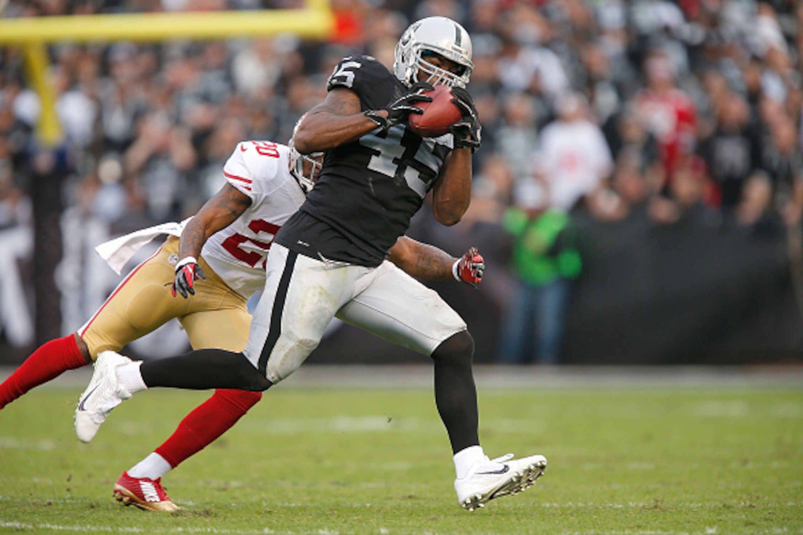 OAKLAND, CA - DECEMBER 07:  Marcel Reece #45 of the Oakland Raiders completes a 14 yard pass in the fourth quarter in front of Perrish Cox #20 of the San Francisco 49ers at O.co Coliseum on December 7, 2014 in Oakland, California.  (Photo by Brian Bahr/Ge