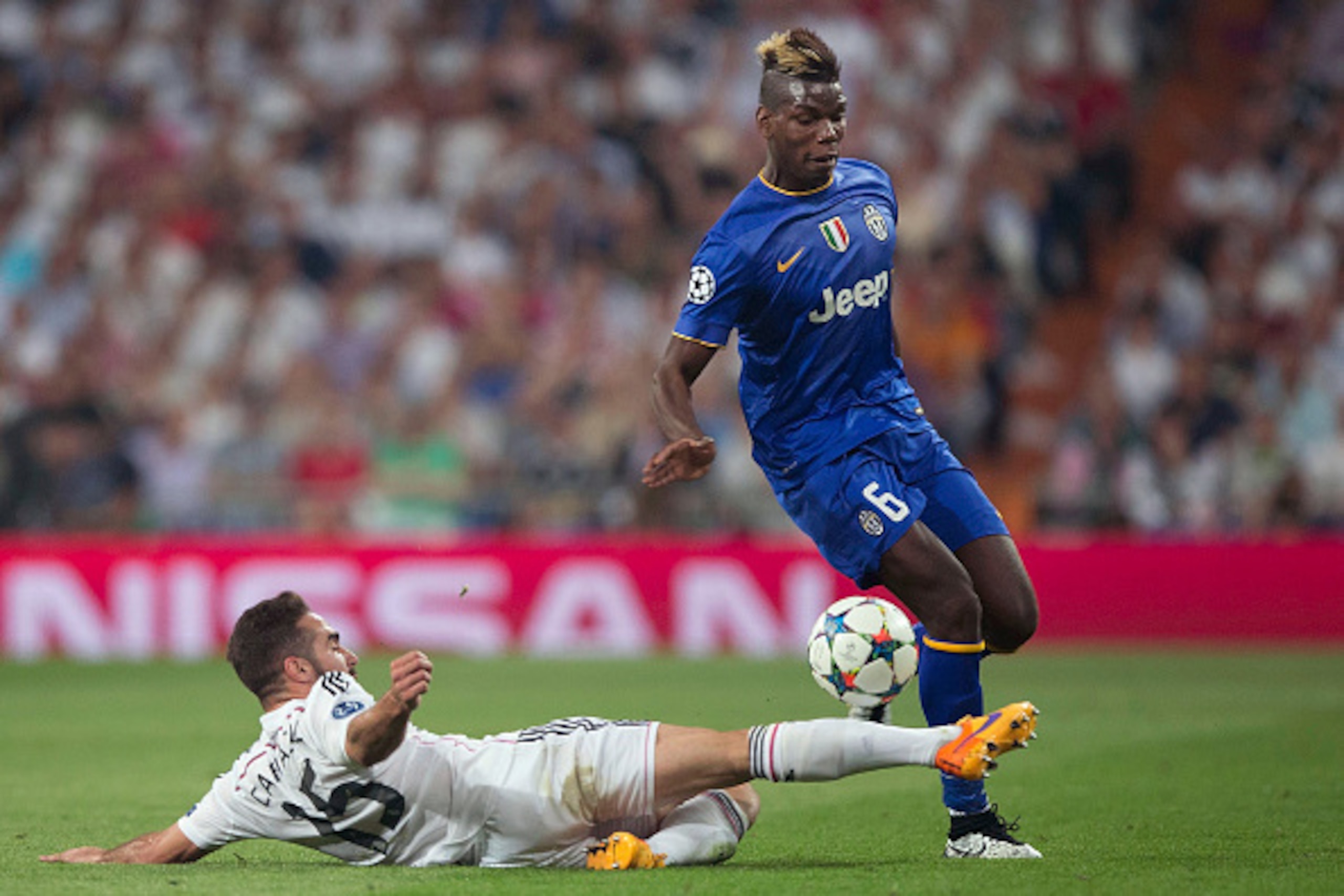 MADRID, SPAIN - MAY 13:  Paul Pogba of Juventus is tackled  by Daniel Carvajal of Real Madrid during the UEFA Champions League Semi Final, second leg match between Real Madrid and Juventus at Estadio Santiago Bernabeu on May 13, 2015 in Madrid, Spain.  (P