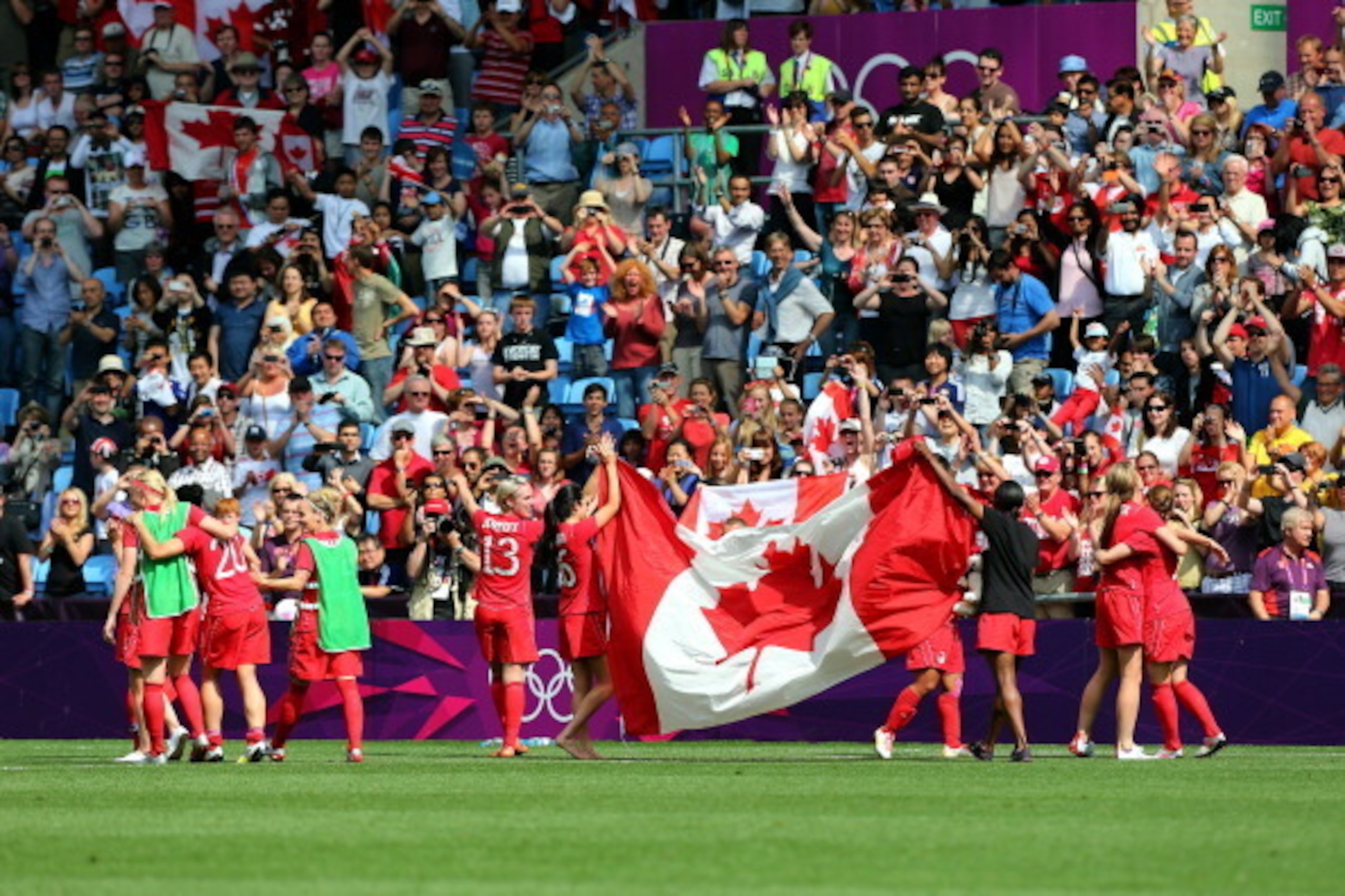 COVENTRY, ENGLAND - AUGUST 09:  Canada players celebrates after they defeated France 1-0 during the Women's Football Bronze Medal match between Canada and France, on Day 13 of the London 2012 Olympic at City of Coventry Stadium on August 9, 2012 in Covent