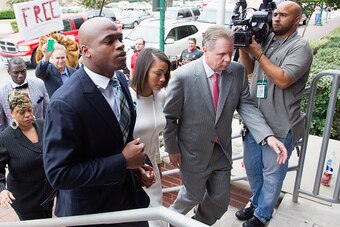 CONROE, TX - NOVEMBER 04:  Football running back Adrian Peterson of the Minnesota Vikings arrives for a court hearing on charges of child abuse with his  wife Ashley Brown at the Montgomery County Courthouse on November 4, 2014 in Conroe, Texas. Peterson 