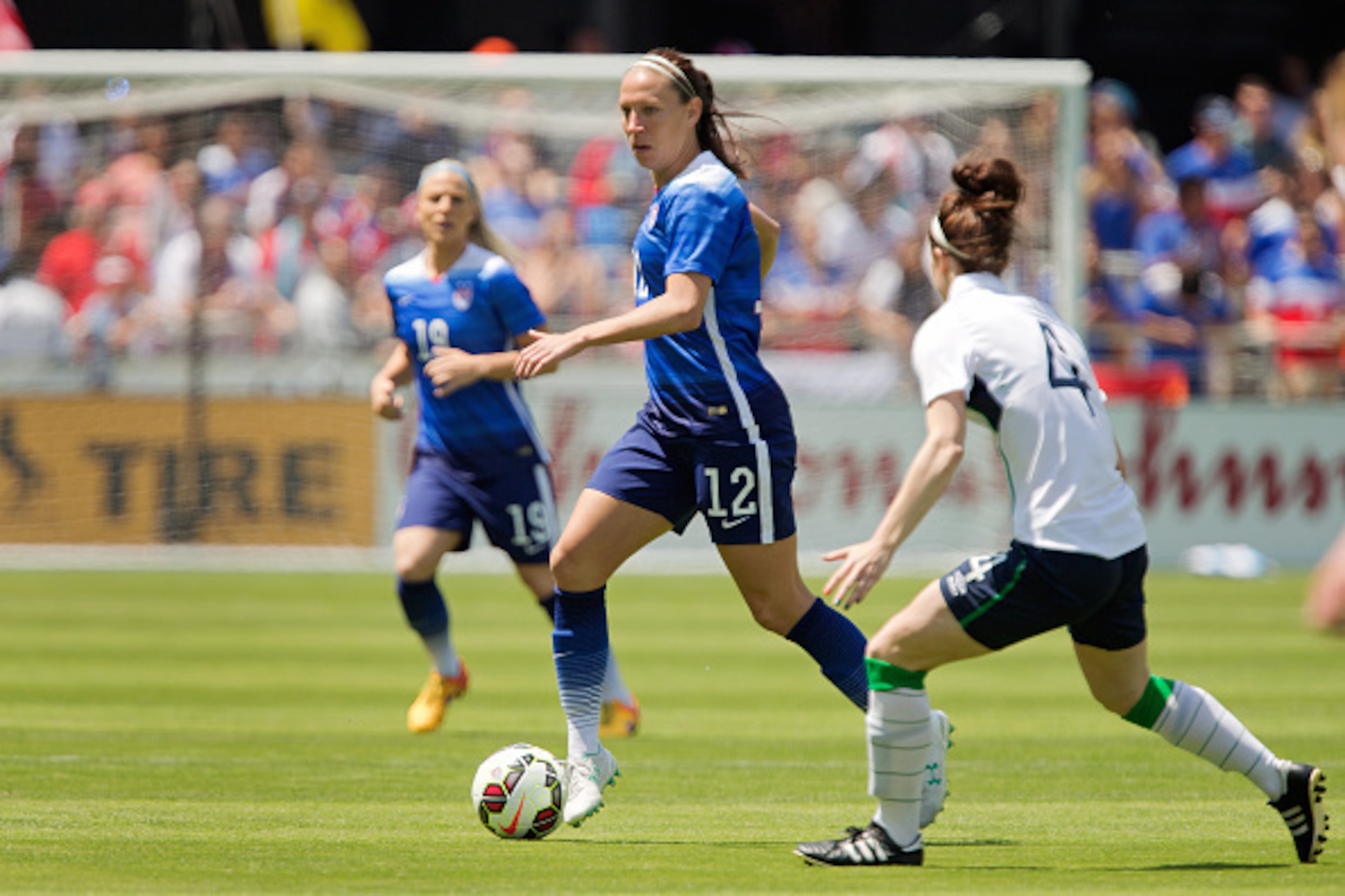 SAN JOSE, CA - MAY 10:  Lauren Holiday #12 of the United States advances the ball against Lauren Duggan #4 of Ireland in the first half of their international friendly match on May 10, 2015 at Avaya Stadium in San Jose, California.  The U.S. won 3-0.  (Ph