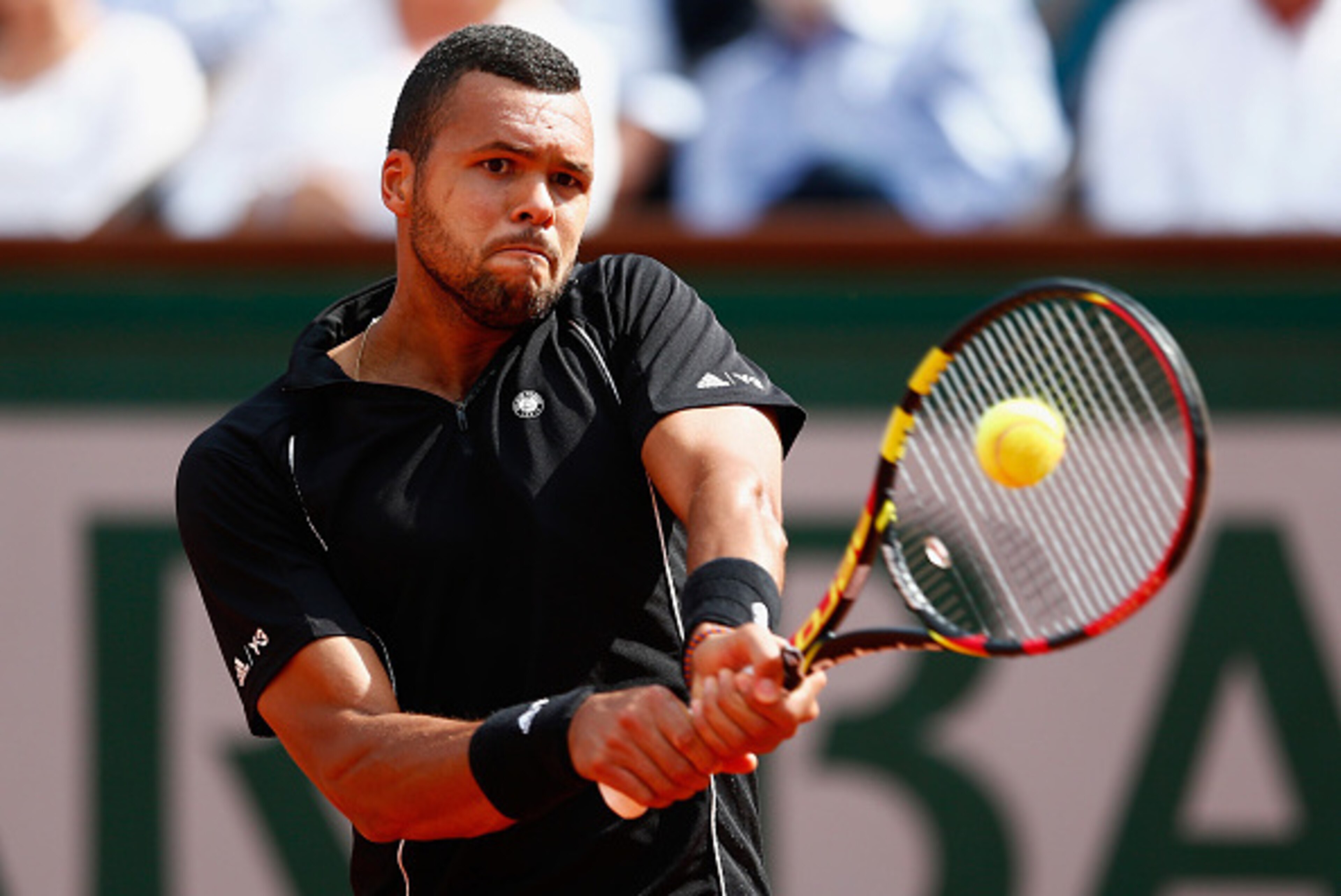 PARIS, FRANCE - JUNE 02:  Jo-Wilfried Tsonga of France plays a backhand during his Men's quarter final match against Kei Nishikori of Japan on day of the 2015 French Open at Roland Garros on June 2, 2015 in Paris, France.  (Photo by Julian Finney/Getty Im