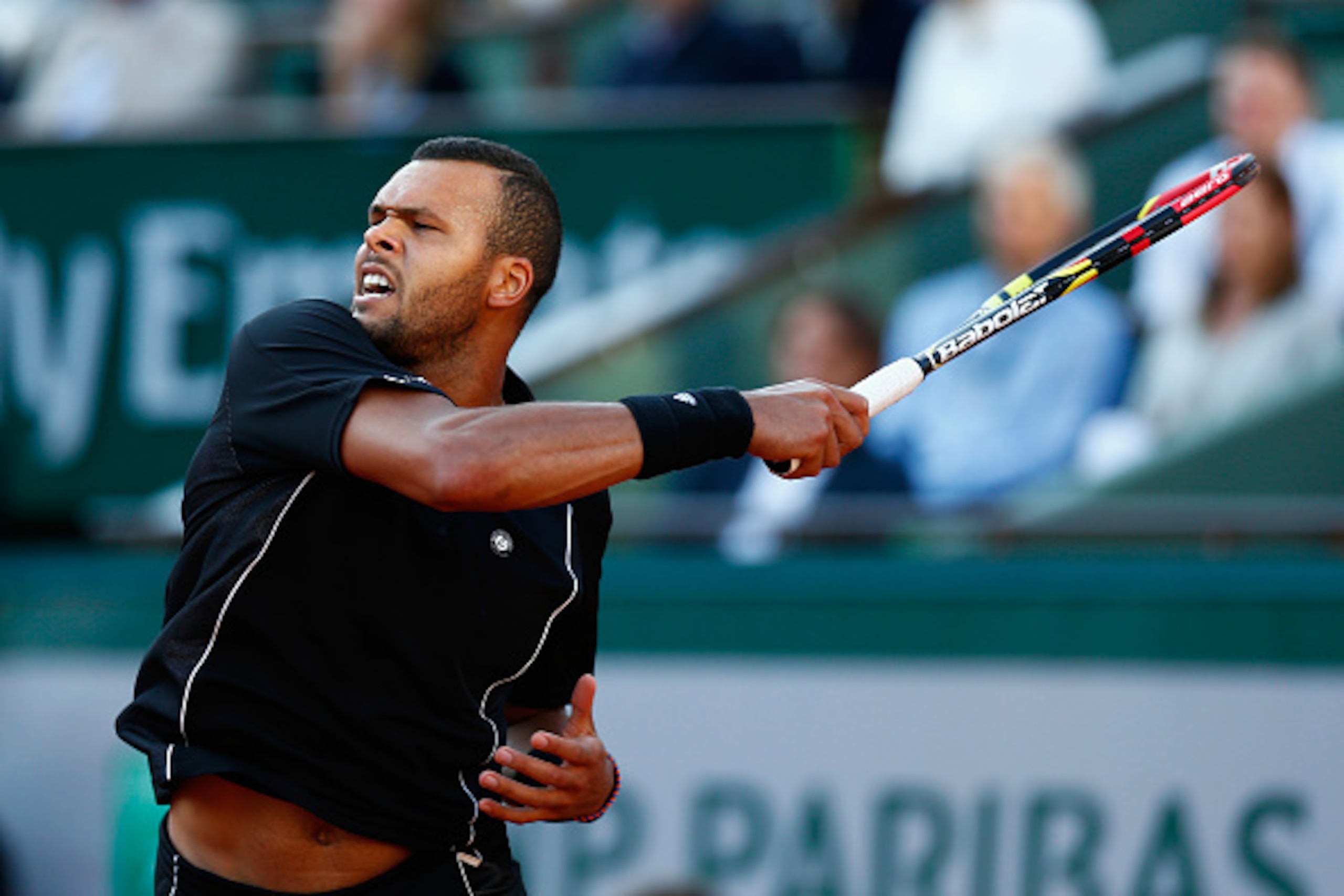 PARIS, FRANCE - JUNE 02: Jo-Wilfried Tsonga of France returns a shot during his Men's quarter final match against Kei Nishikori of Japan on day of the 2015 French Open at Roland Garros on June 2, 2015 in Paris, France. (Photo by Julian Finney/Getty Imag PARIS, FRANCE - JUNE 02: Jo-Wilfried Tsonga of France returns a shot during his Men's quarter final match against Kei Nishikori of Japan on day of the 2015 French Open at Roland Garros on June 2, 2015 in Paris, France. (Photo by Julian Finney/Getty Imag