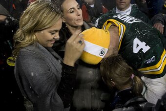Favre celebrates a playoff win with Deanna (center), Brittany (left) and Breleigh (right) in 2008.